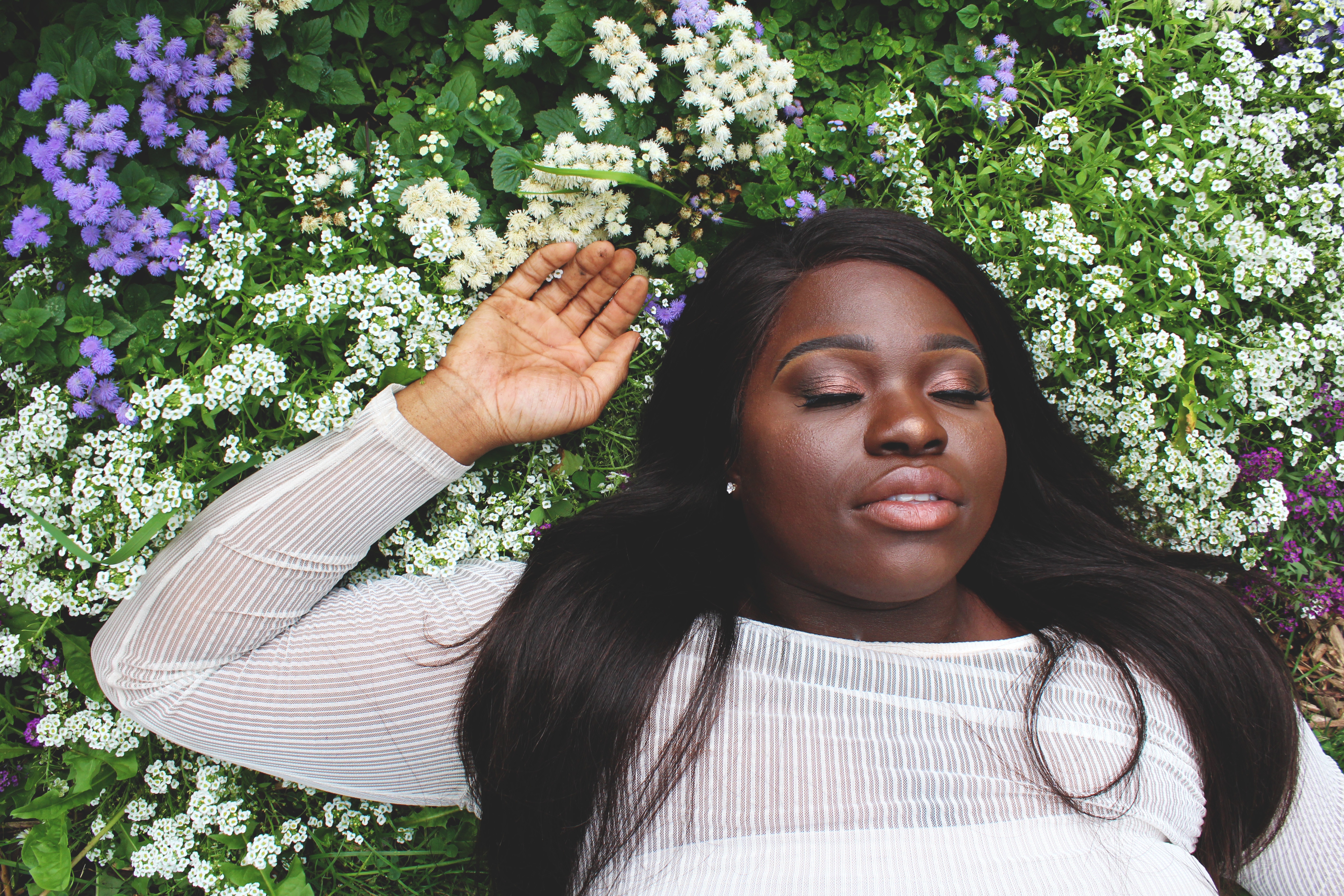 Woman lying in a field of flowers HD Wallpaper