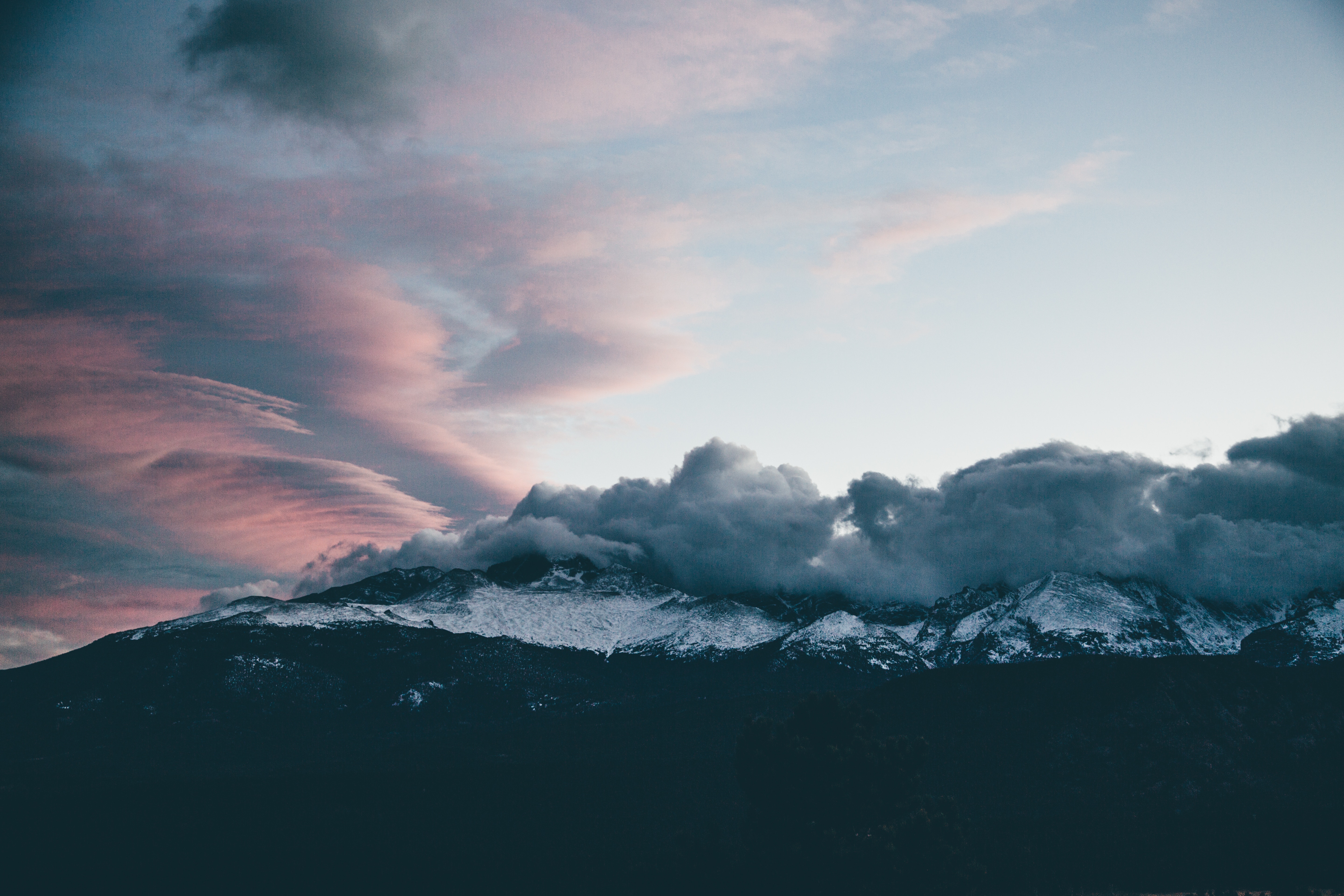 Snow-capped Longs Peak mountain under a colorful sunset sky HD Wallpaper
