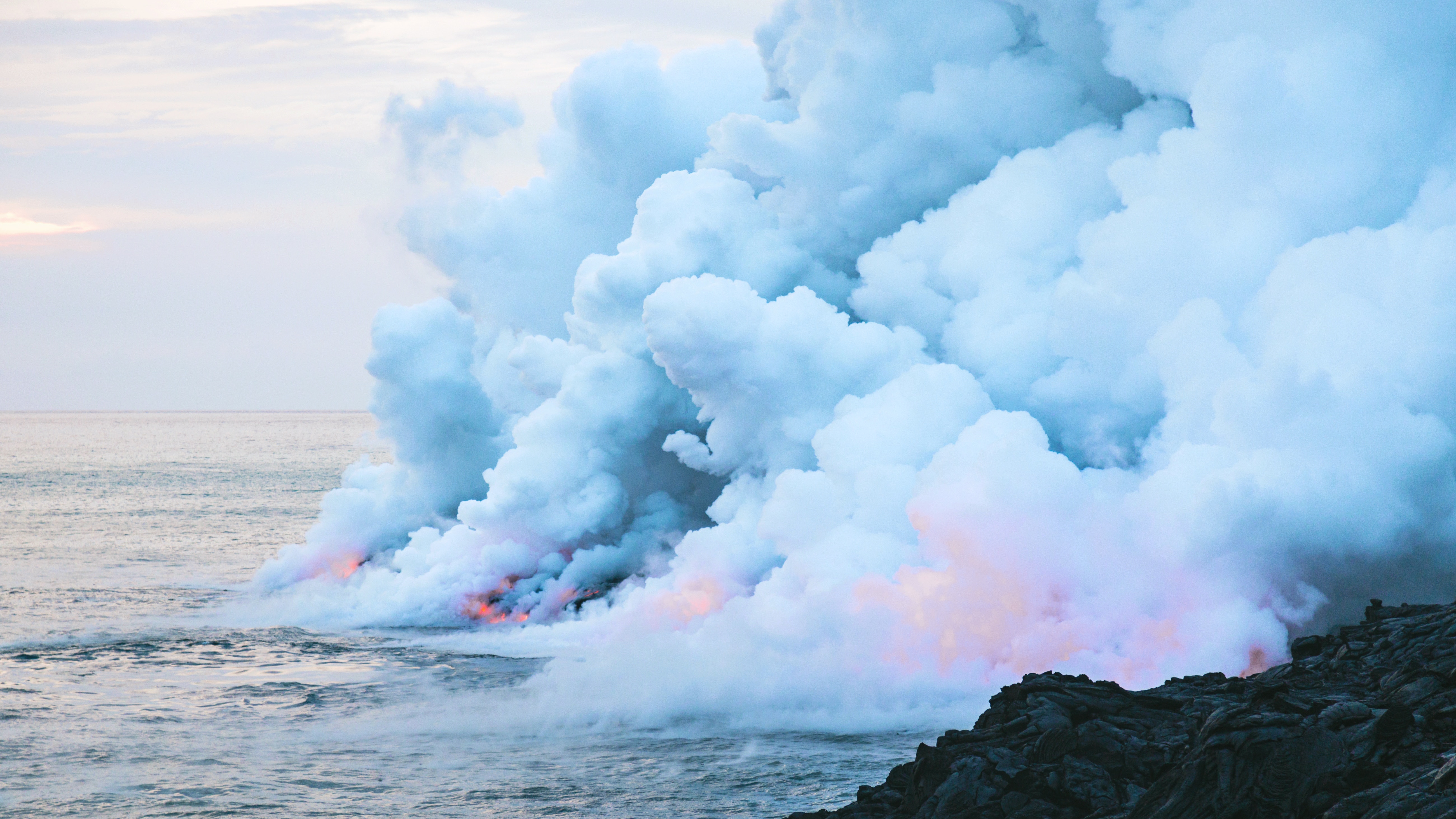 Lava flowing into the ocean with steam and smoke HD Wallpaper
