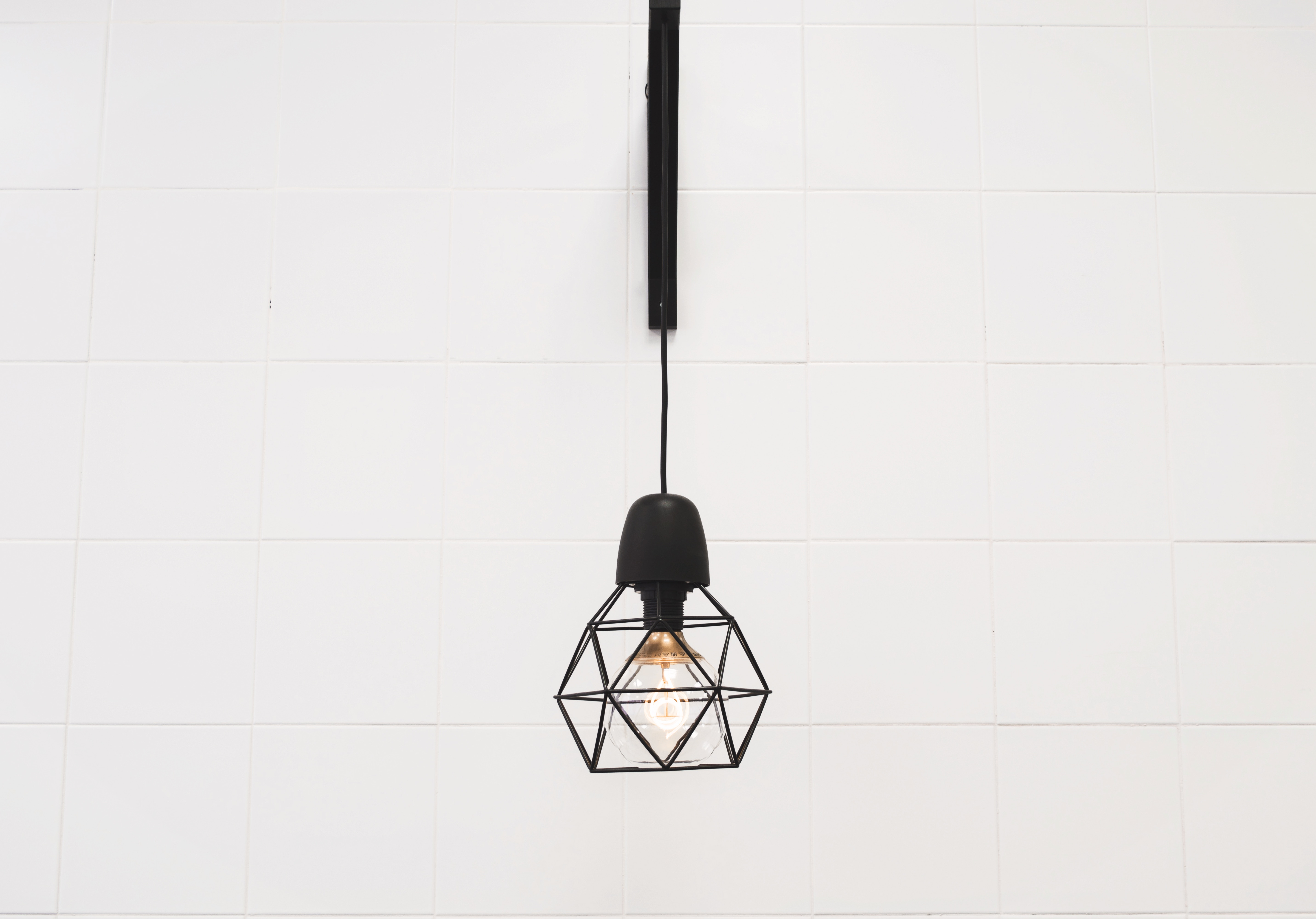 Black geometric hanging light fixture with bulb HD Wallpaper