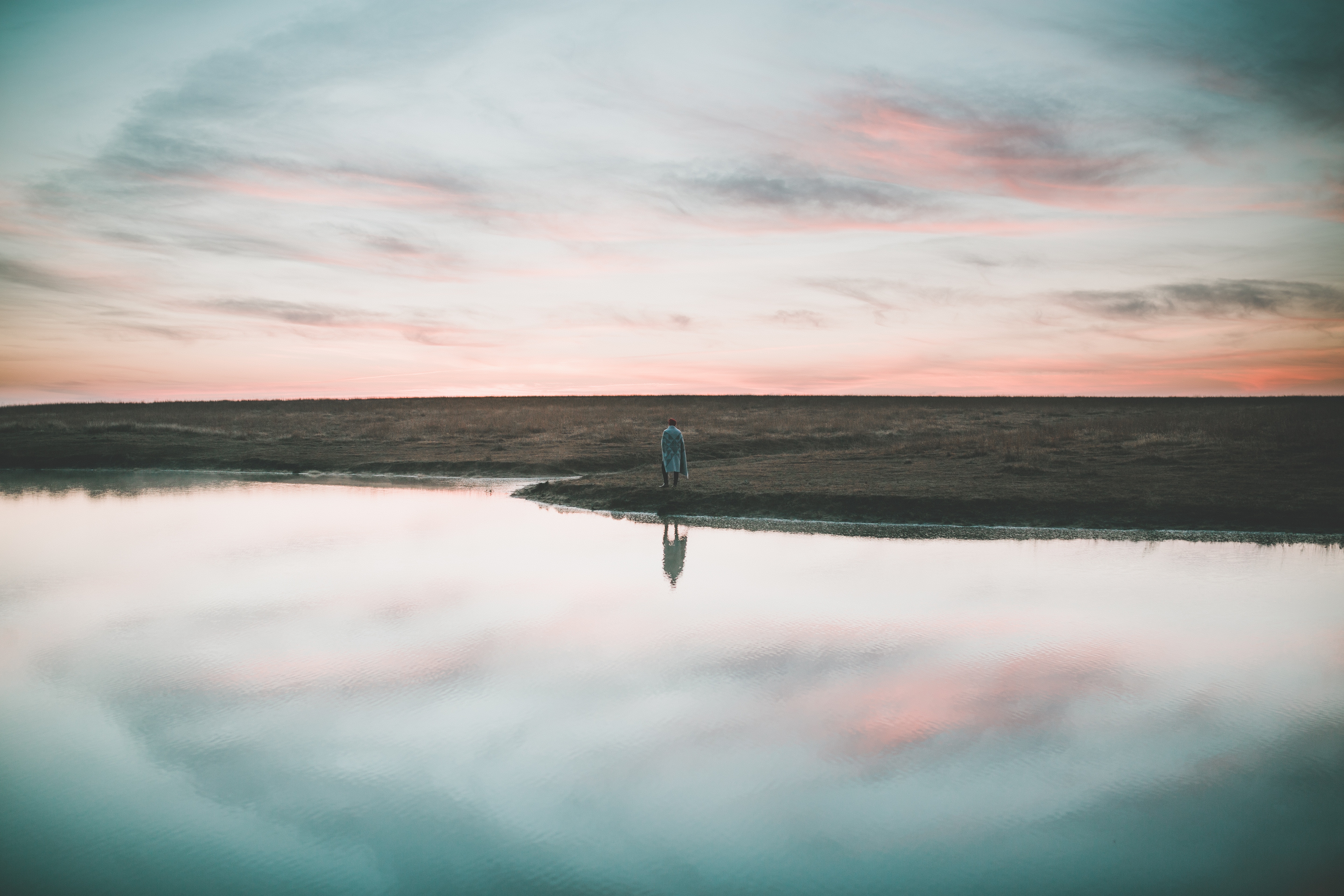 Person reflected in water at sunrise HD Wallpaper