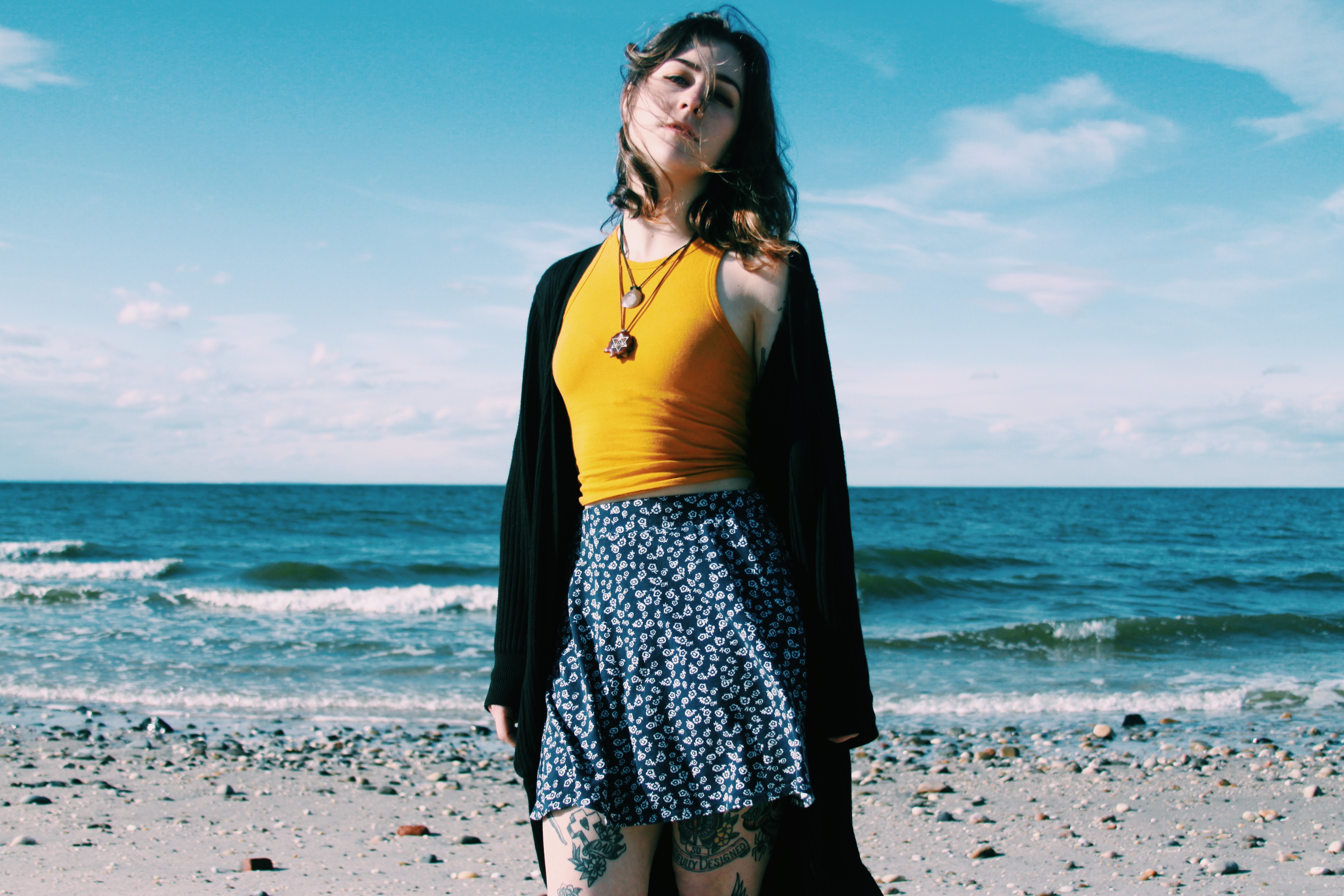 Woman in skirt and necklace on a beach HD Wallpaper