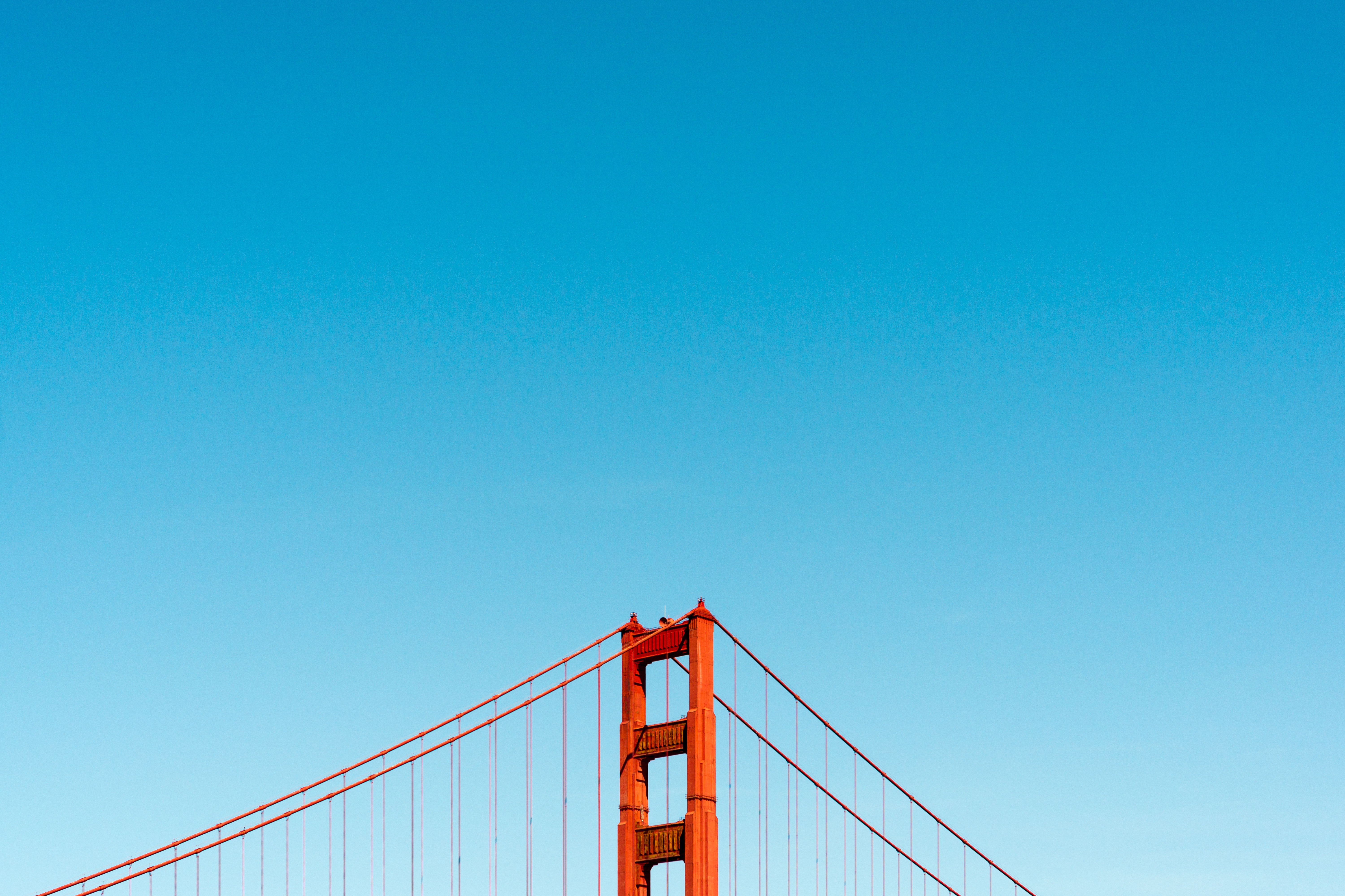 Golden Gate Bridge against a clear blue sky HD Wallpaper