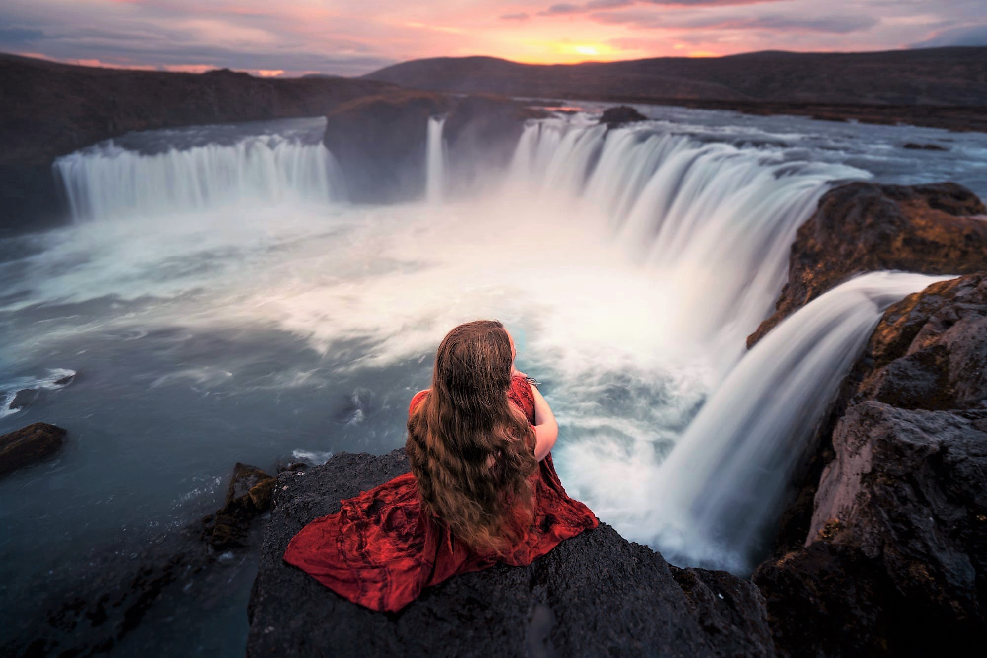 Woman in red dress at Goðafoss waterfall HD Wallpaper