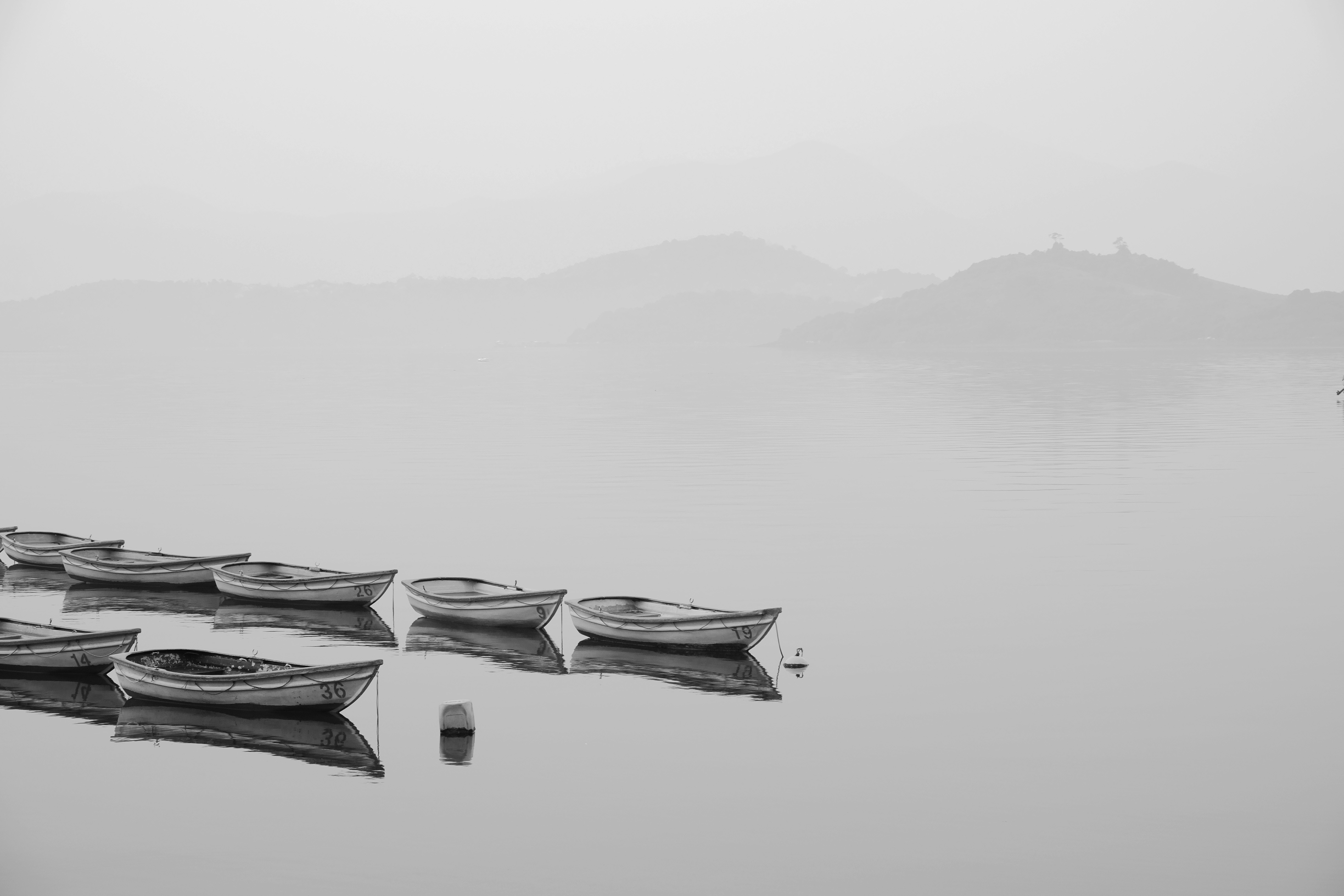 Boats on a Foggy Lake with Mountains HD Wallpaper