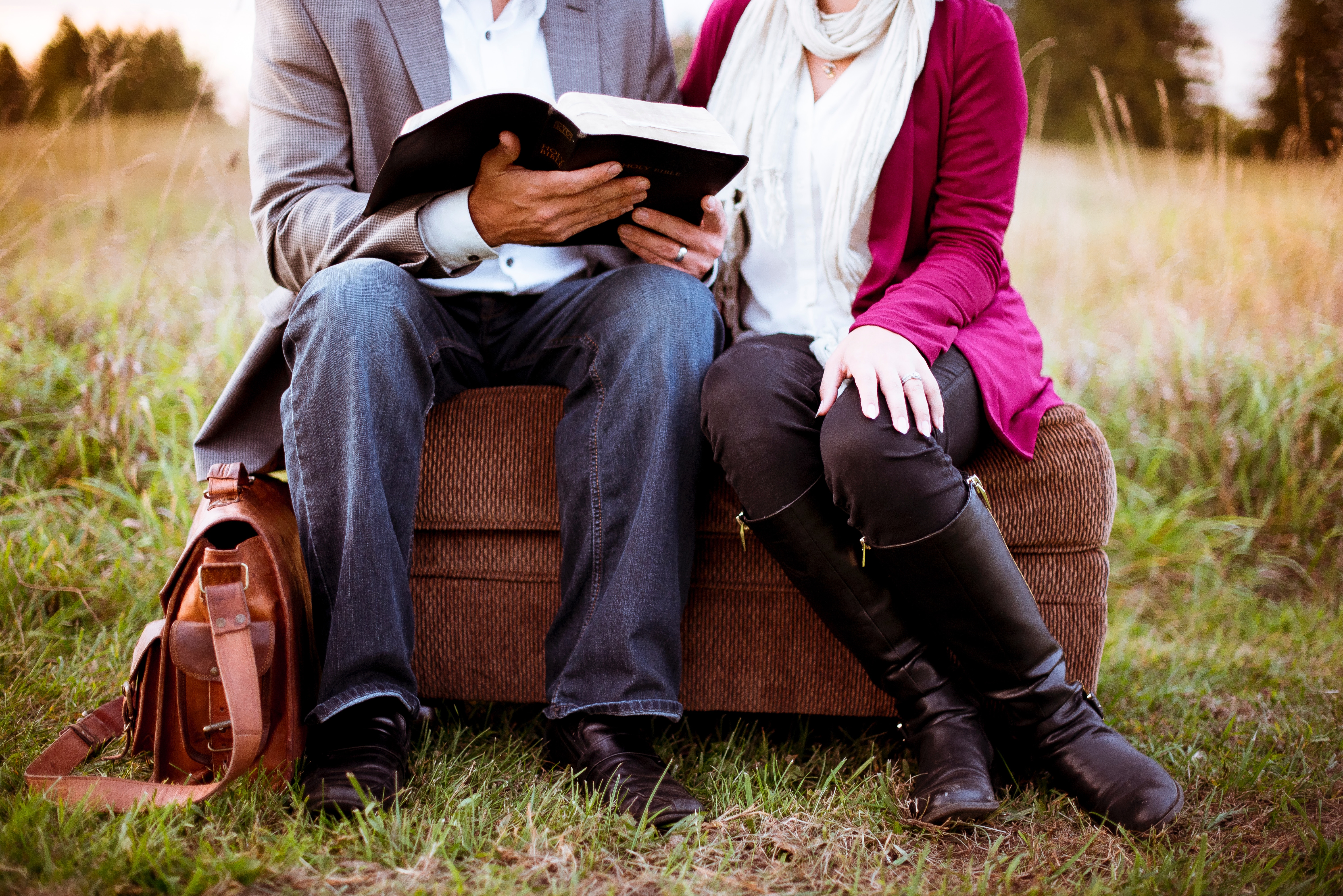Couple Reading the Bible on an Ottoman in a Field HD Wallpaper
