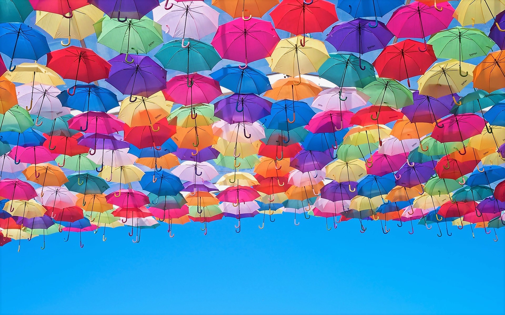 A sky filled with colorful umbrellas HD Wallpaper