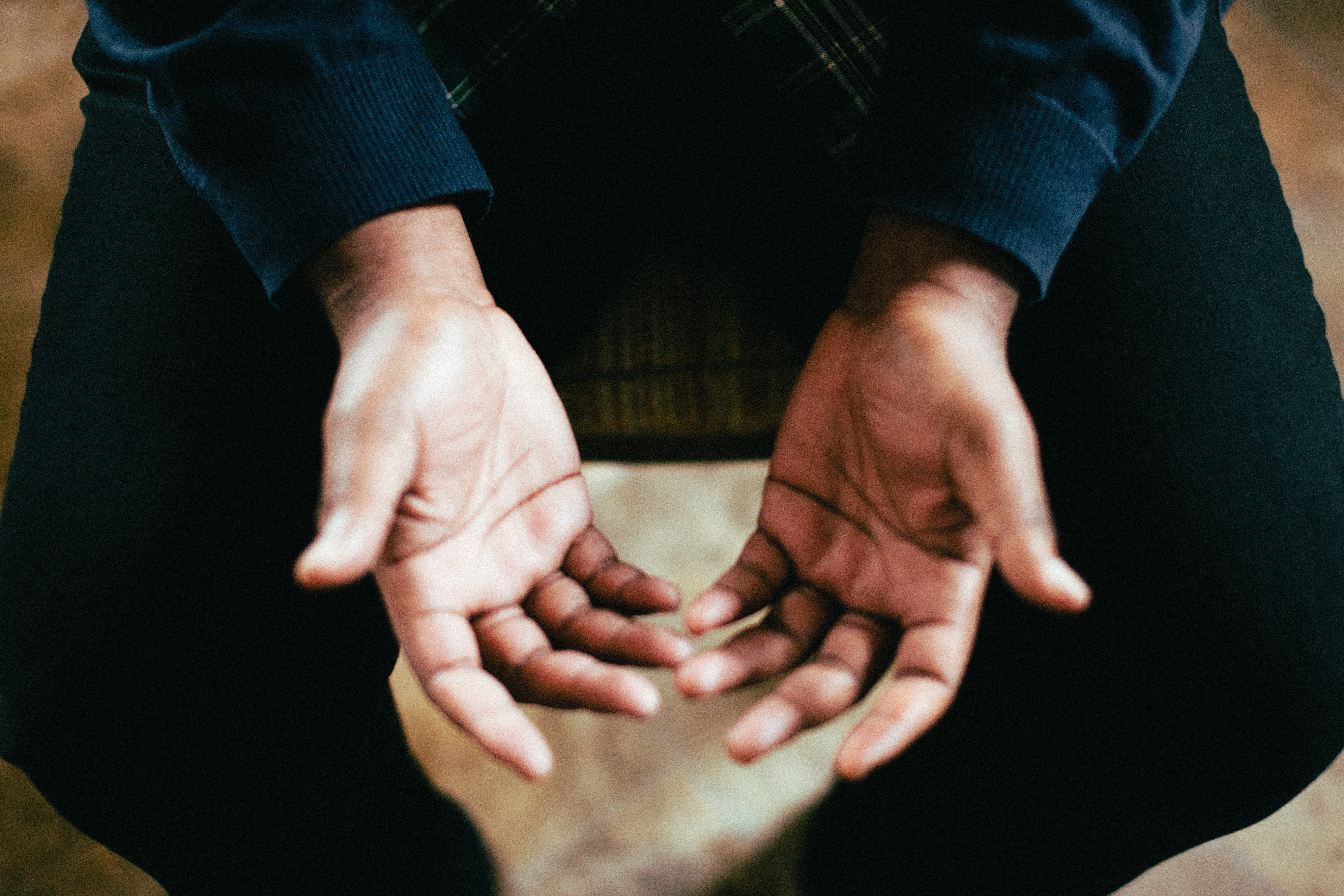 Person with hands open, sitting HD Wallpaper