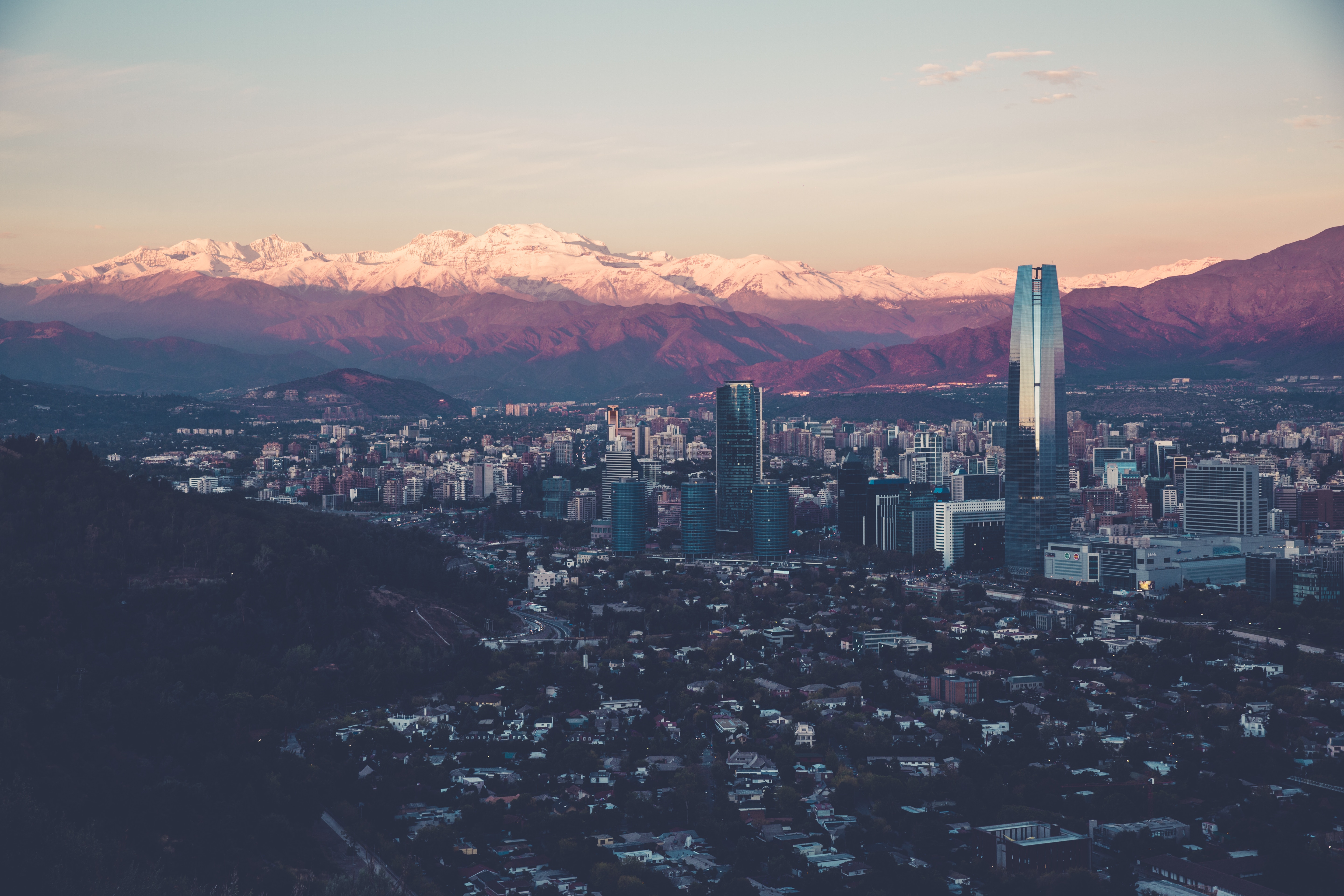 Santiago cityscape with snow-capped Andes mountains at sunset HD Wallpaper
