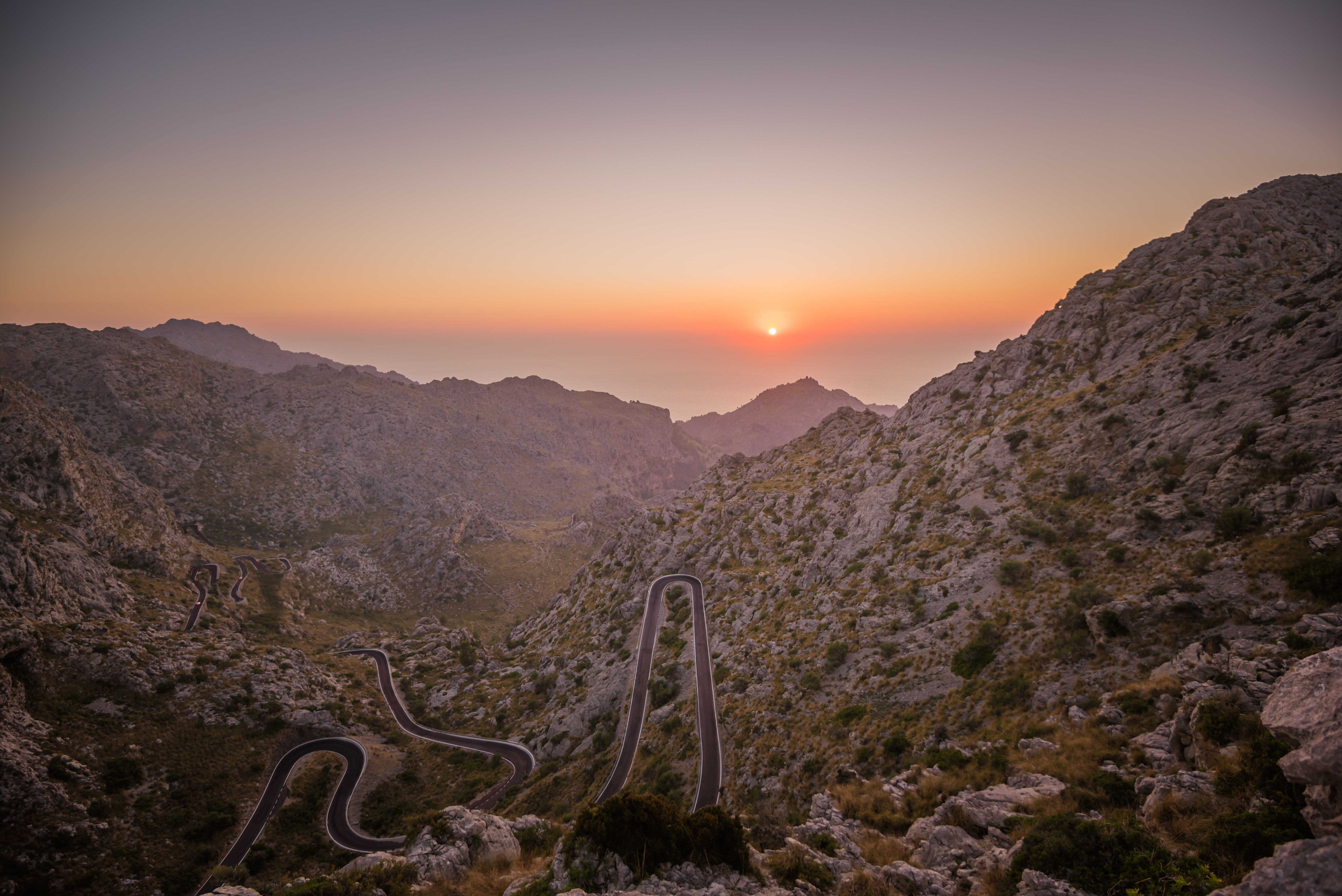 Winding mountain road at sunrise HD Wallpaper