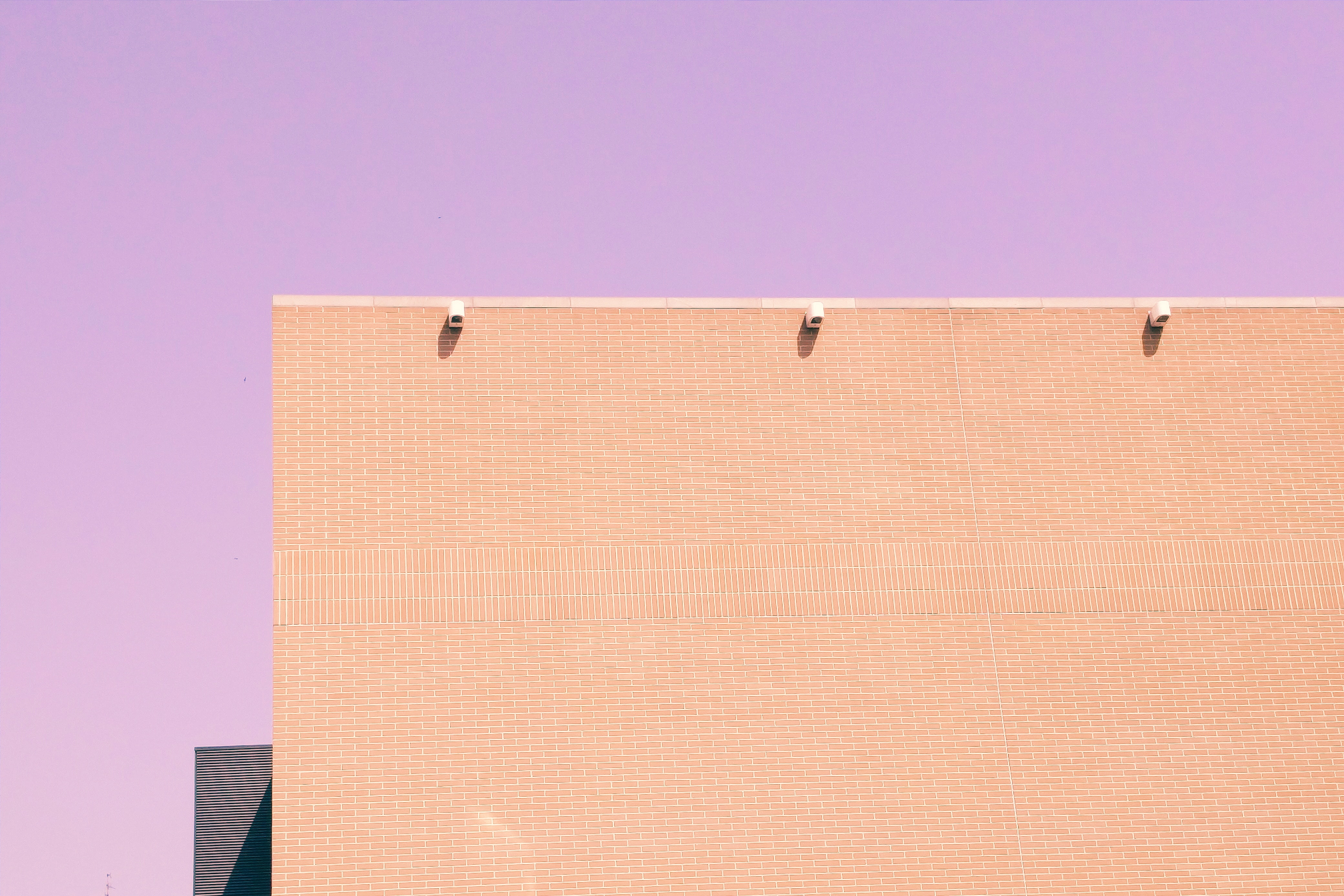 Minimalist Peach Brick Building Against Purple Sky HD Wallpaper