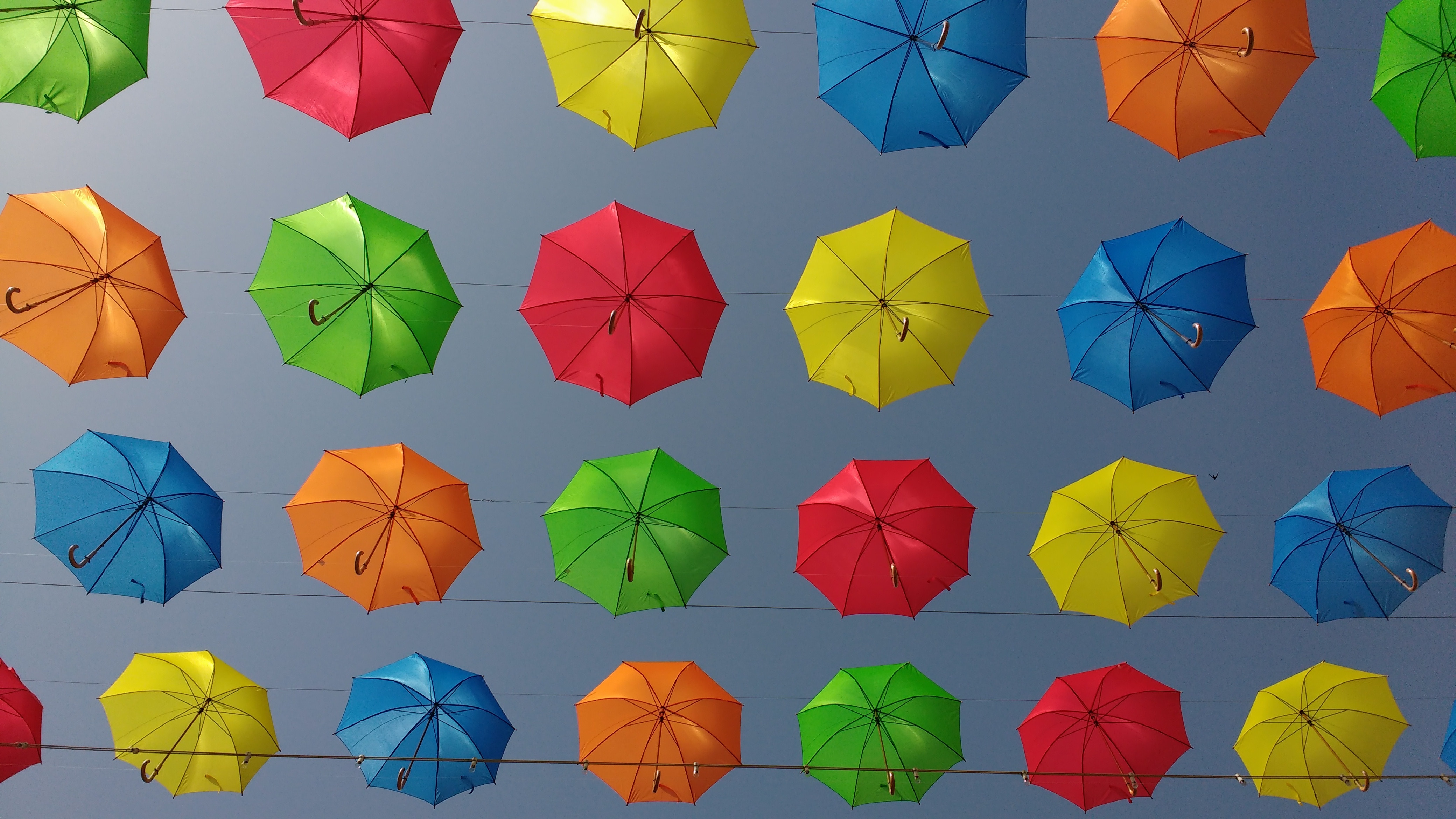Colorful umbrellas suspended in the sky HD Wallpaper