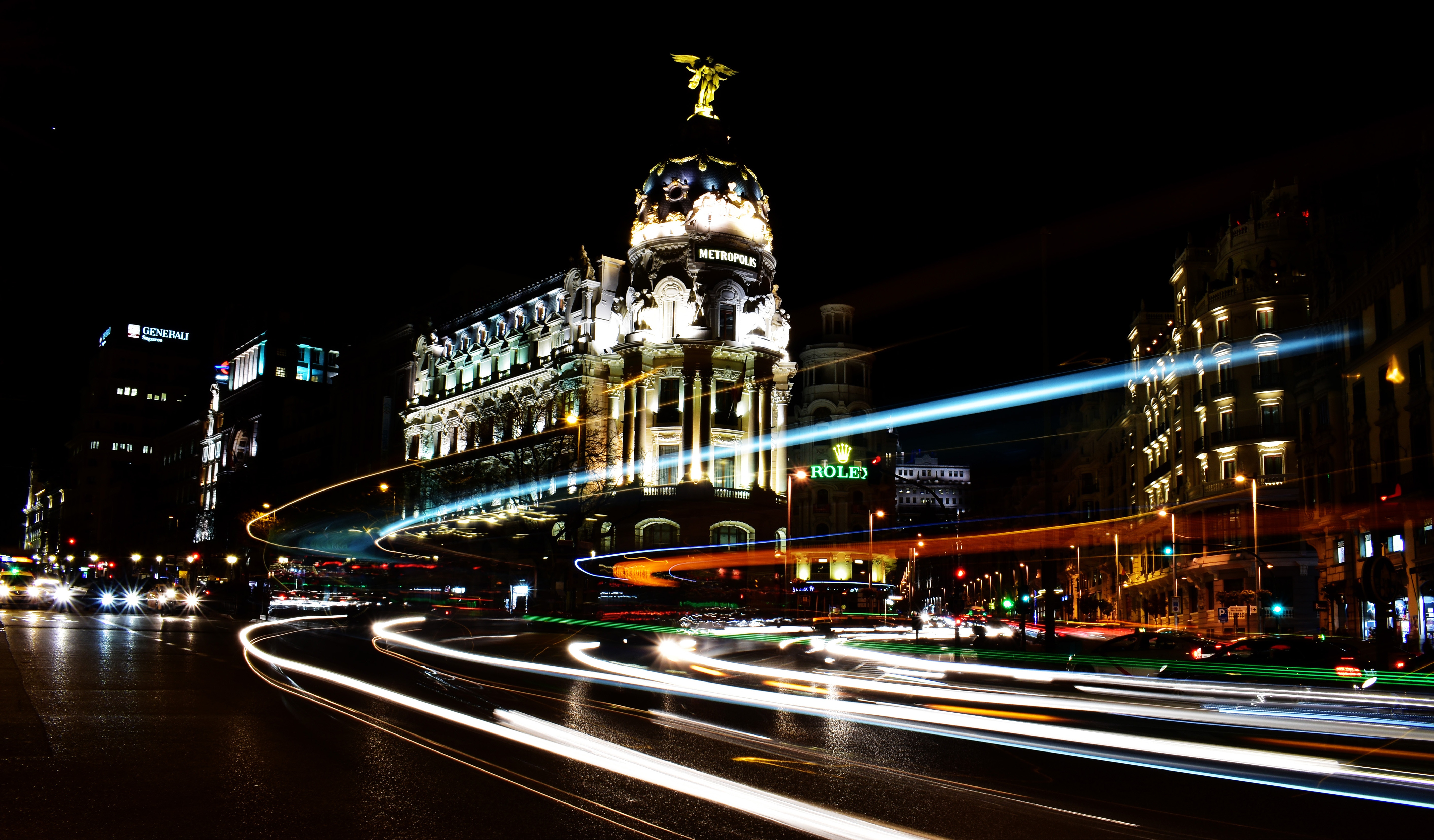 Metropolis building with light trails at night in Madrid HD Wallpaper