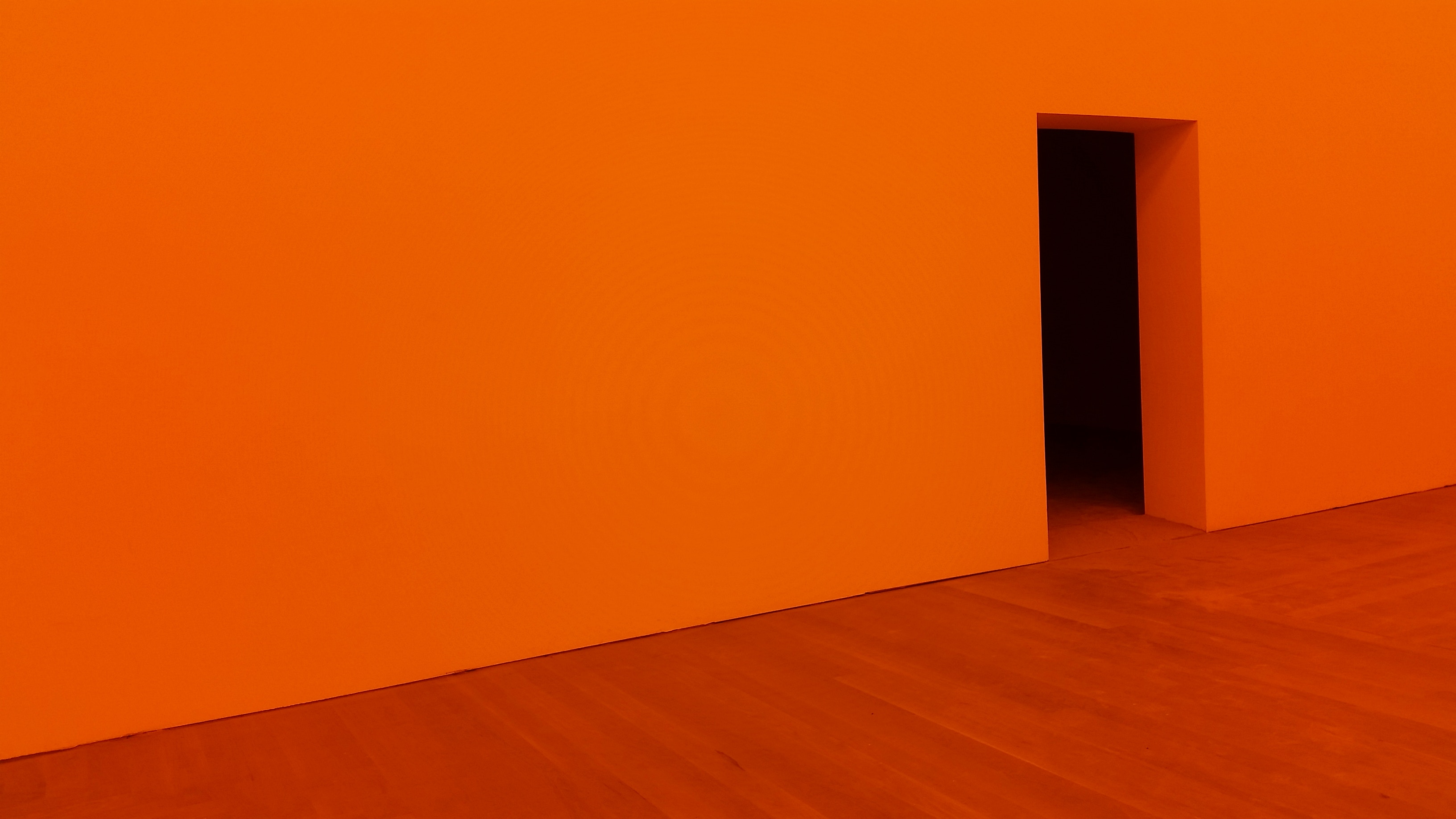 Minimalist orange room with a dark doorway HD Wallpaper