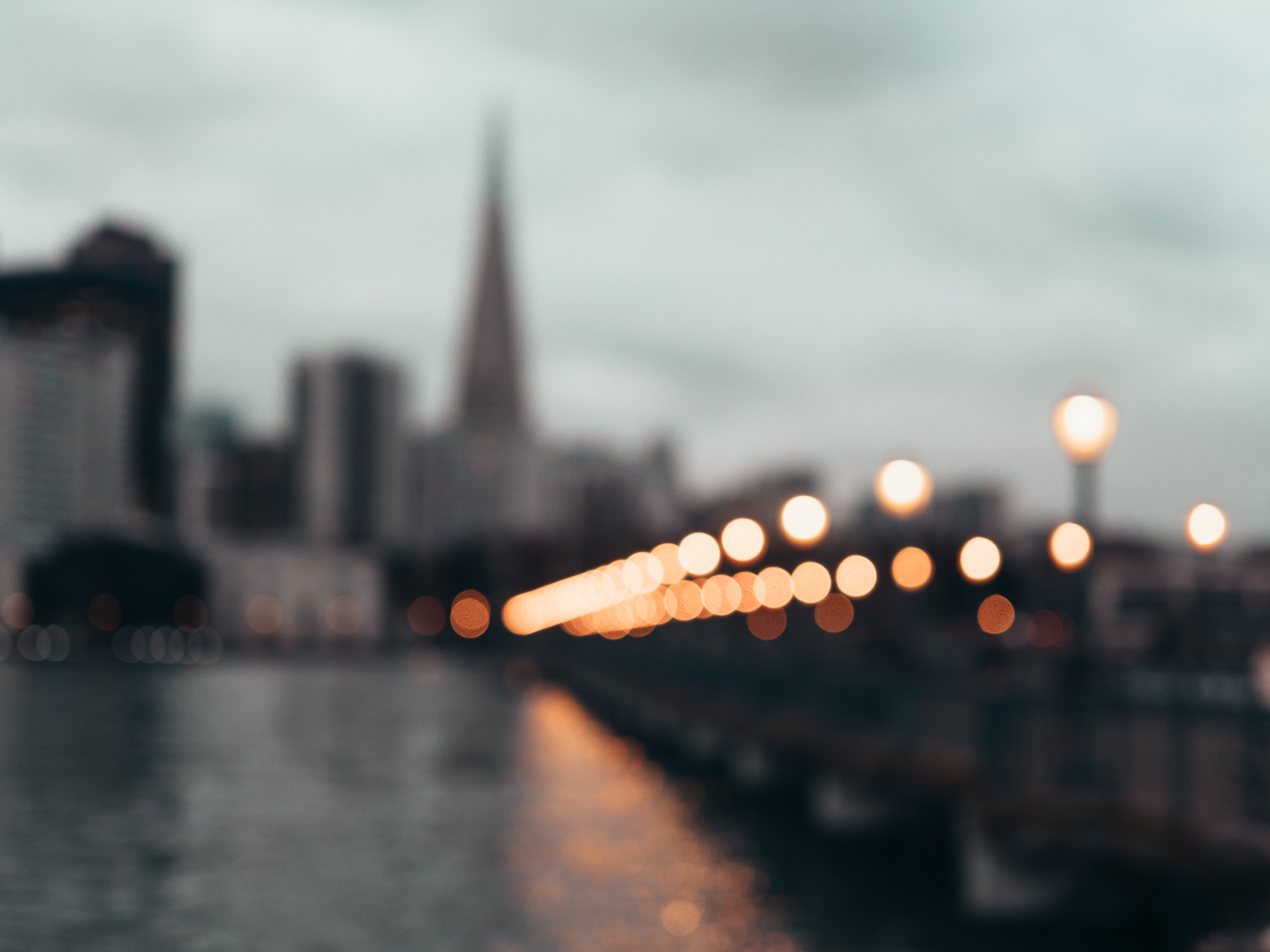 San Francisco skyline with bokeh lights over water HD Wallpaper