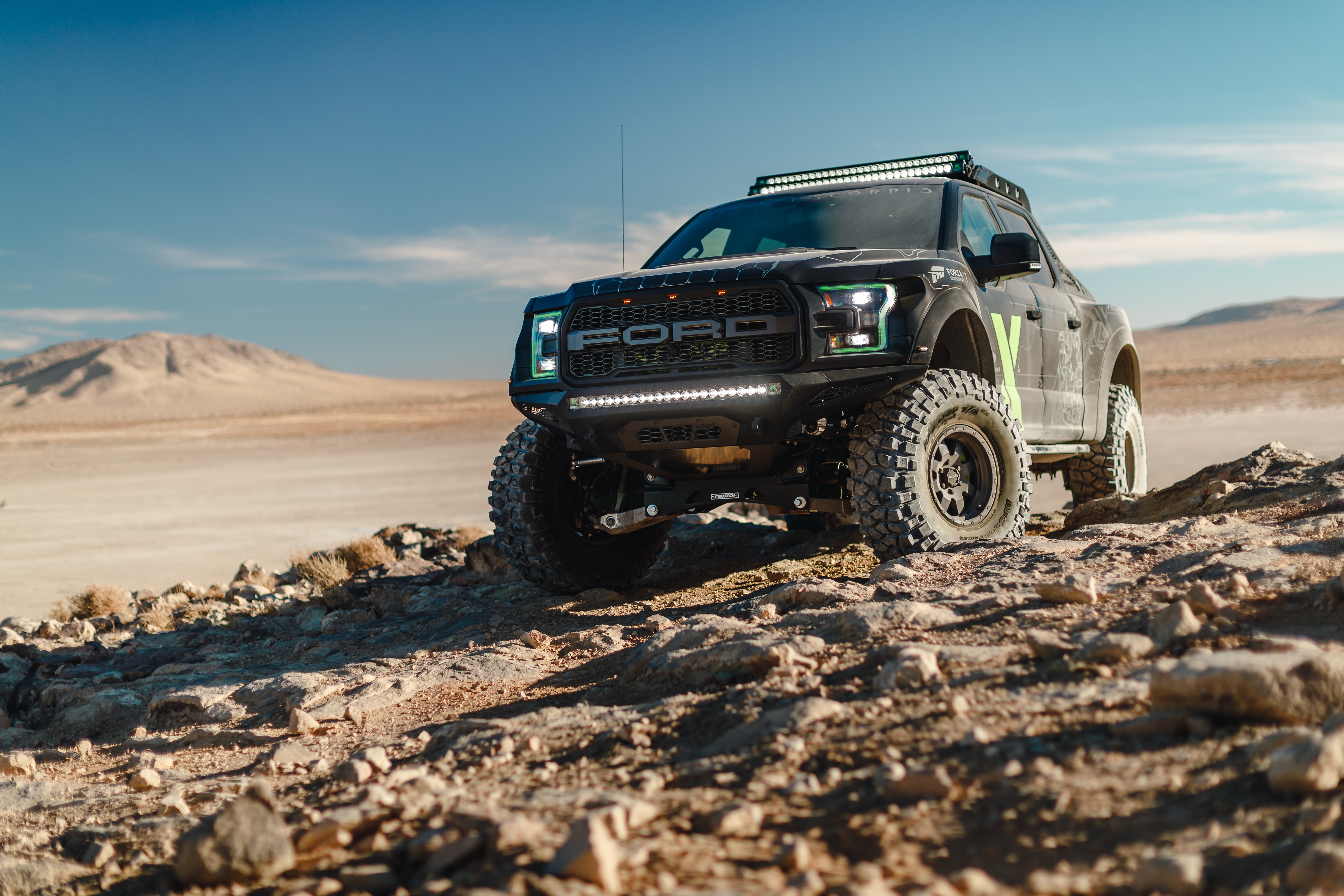 Ford F-150 Raptor off-roading in a desert HD Wallpaper