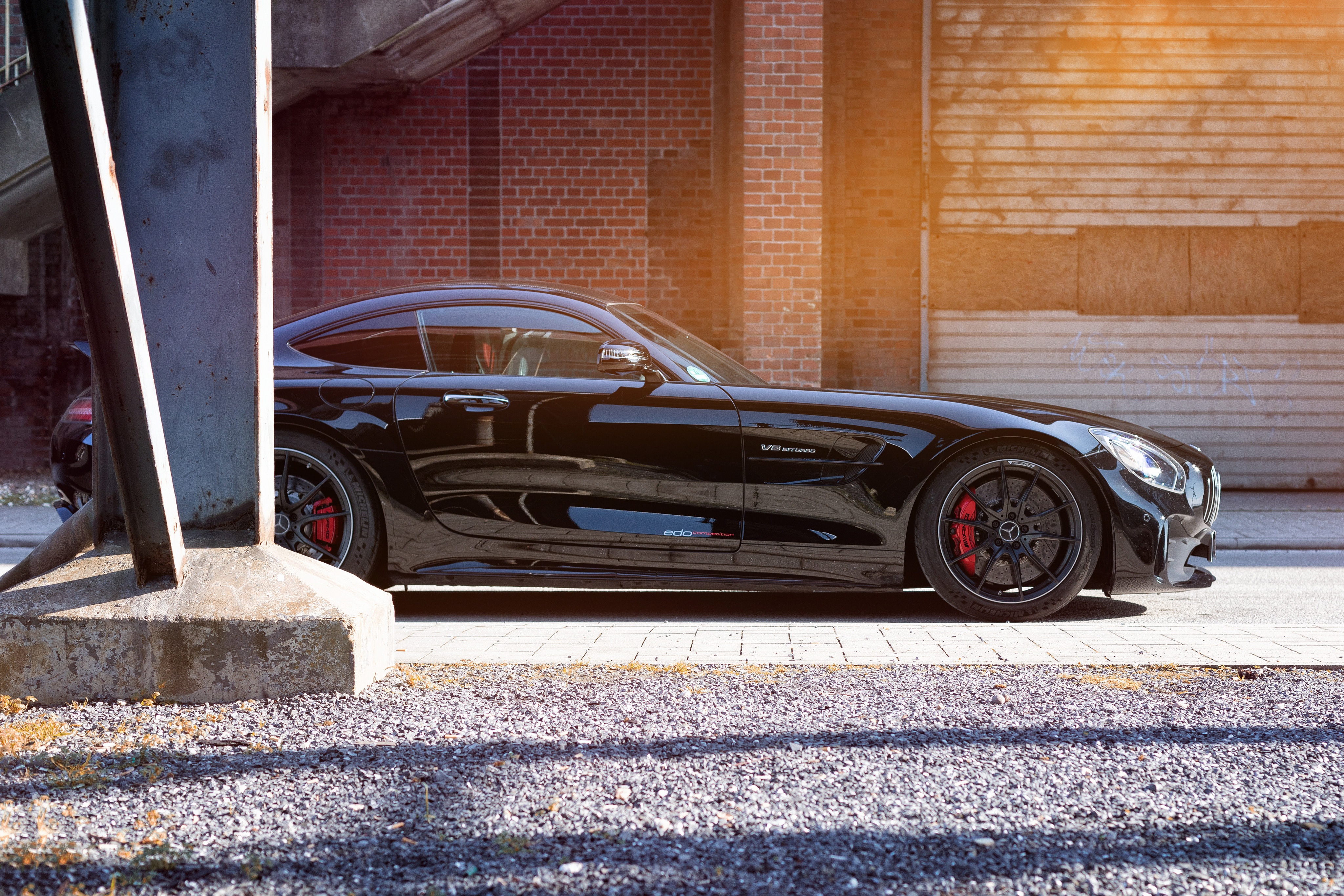 Black Mercedes-AMG GT R parked by brick building HD Wallpaper