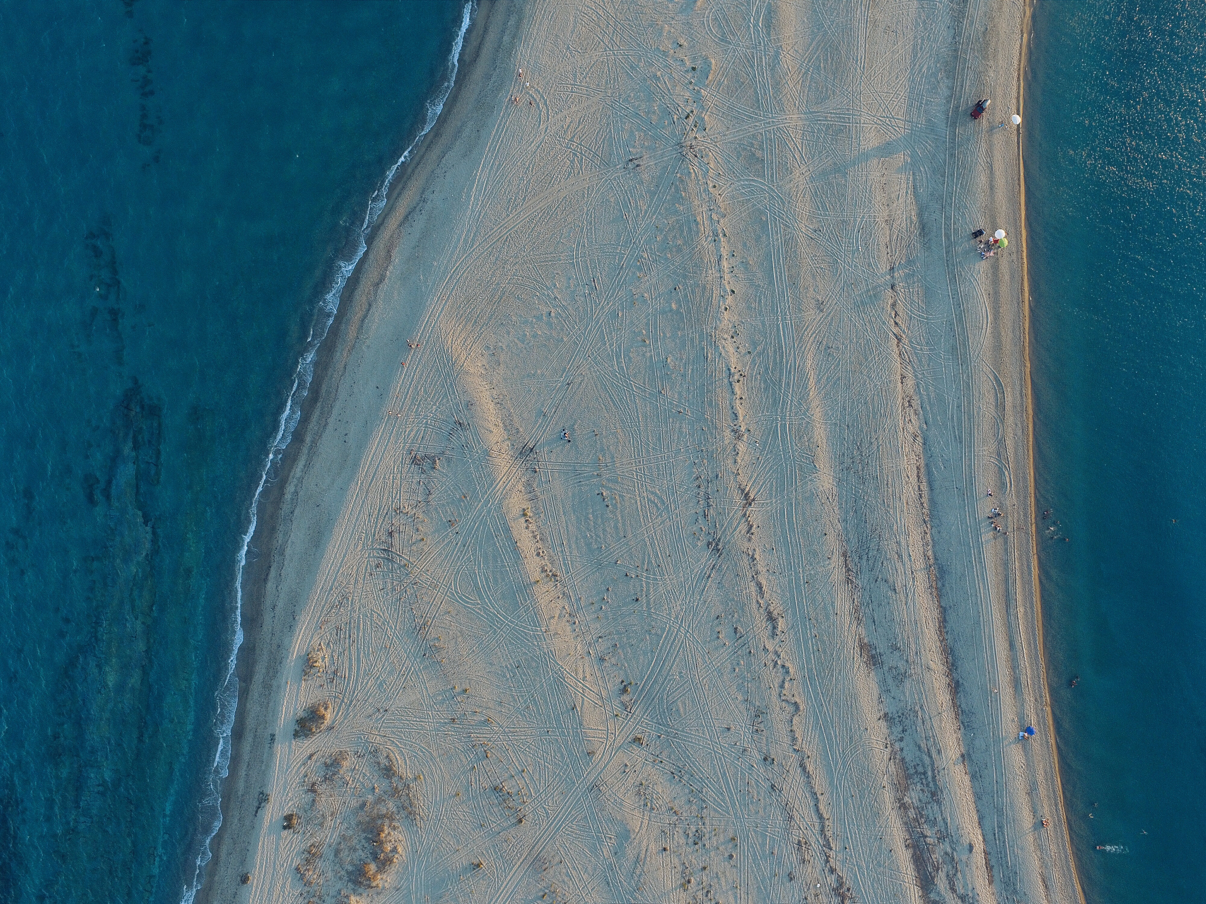 Aerial view of a sandy beach and blue sea HD Wallpaper