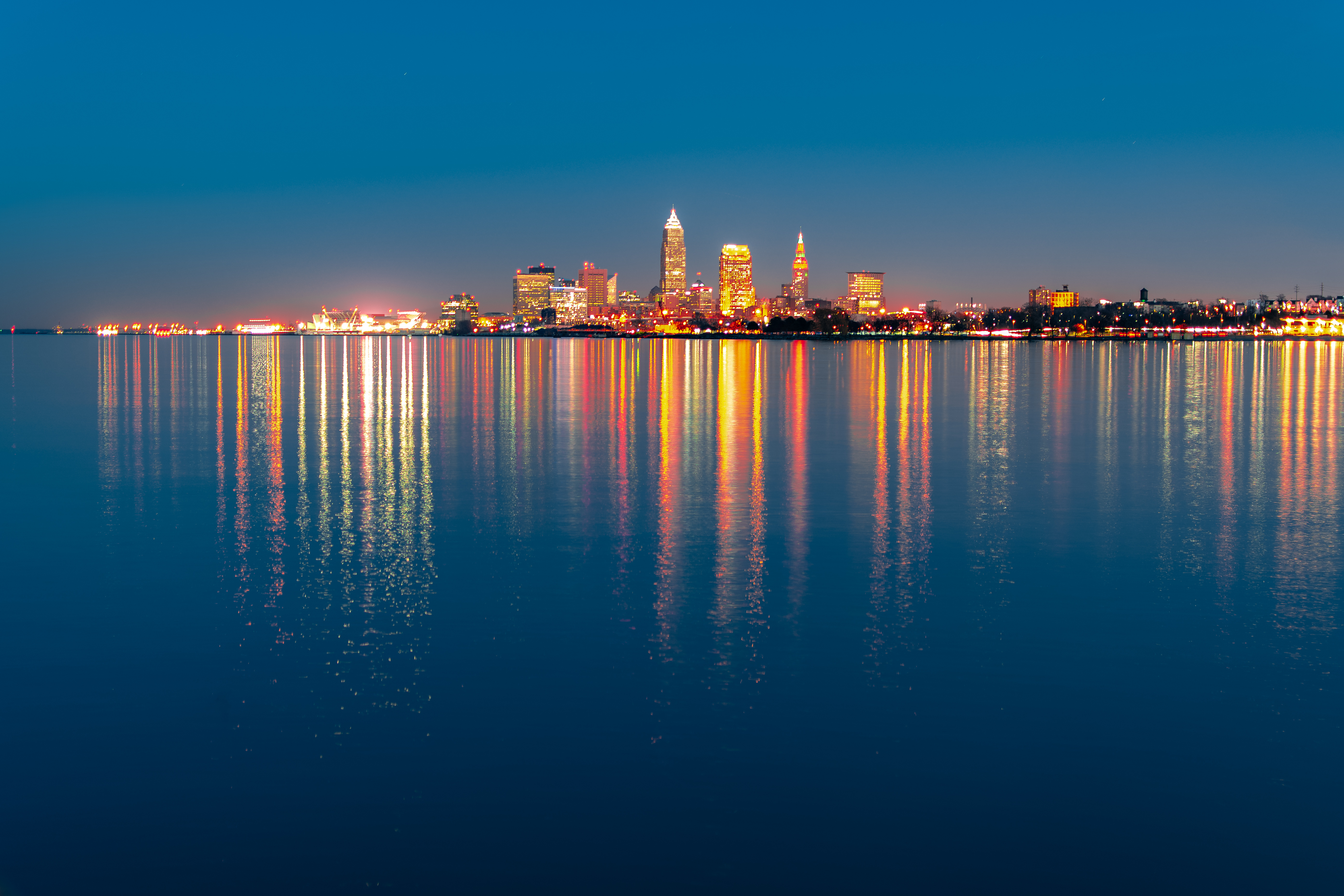 Cleveland skyline at night with reflections on water HD Wallpaper