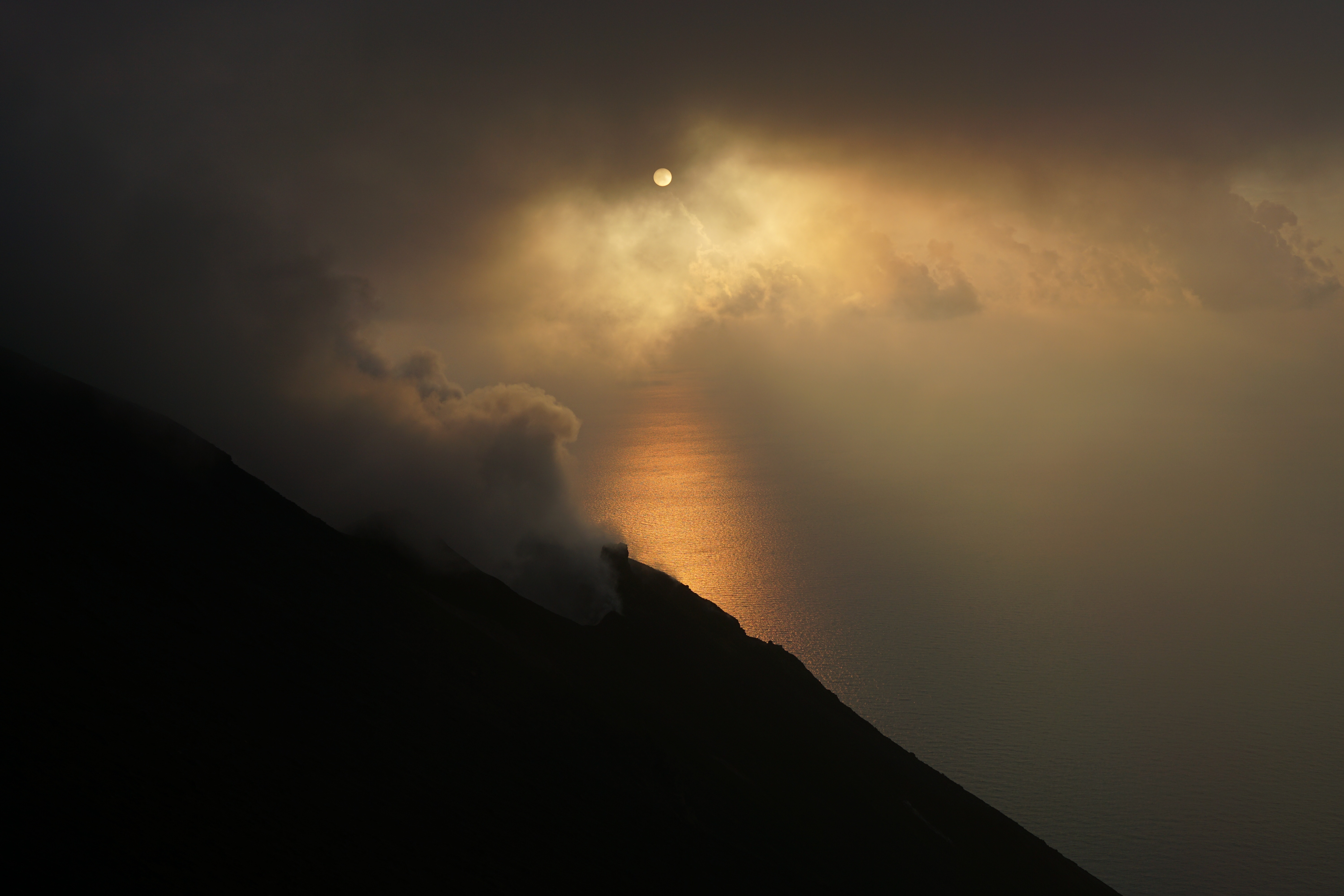 Sunset over the sea with clouds and volcano smoke HD Wallpaper