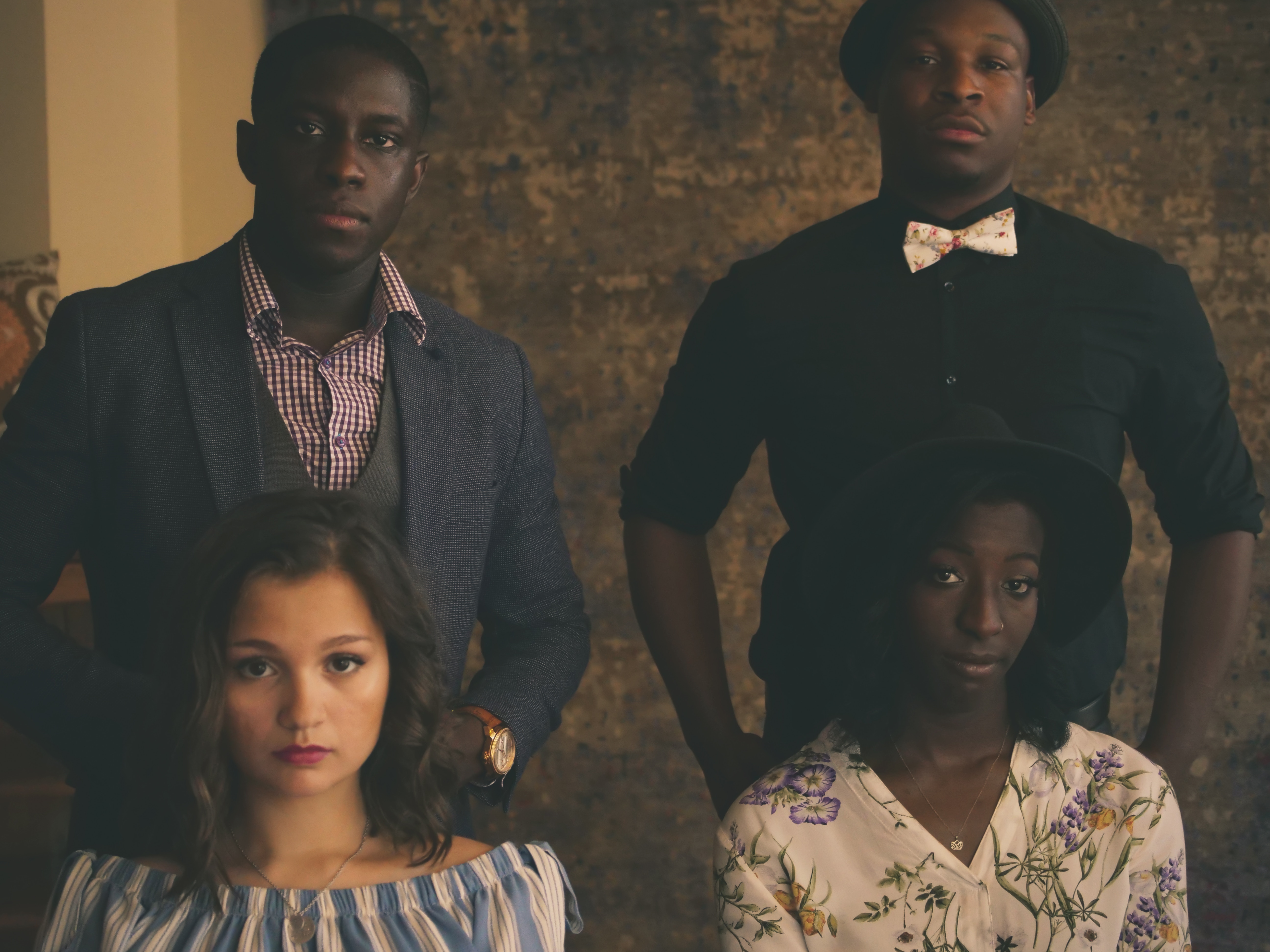Four people posing for a formal photo HD Wallpaper