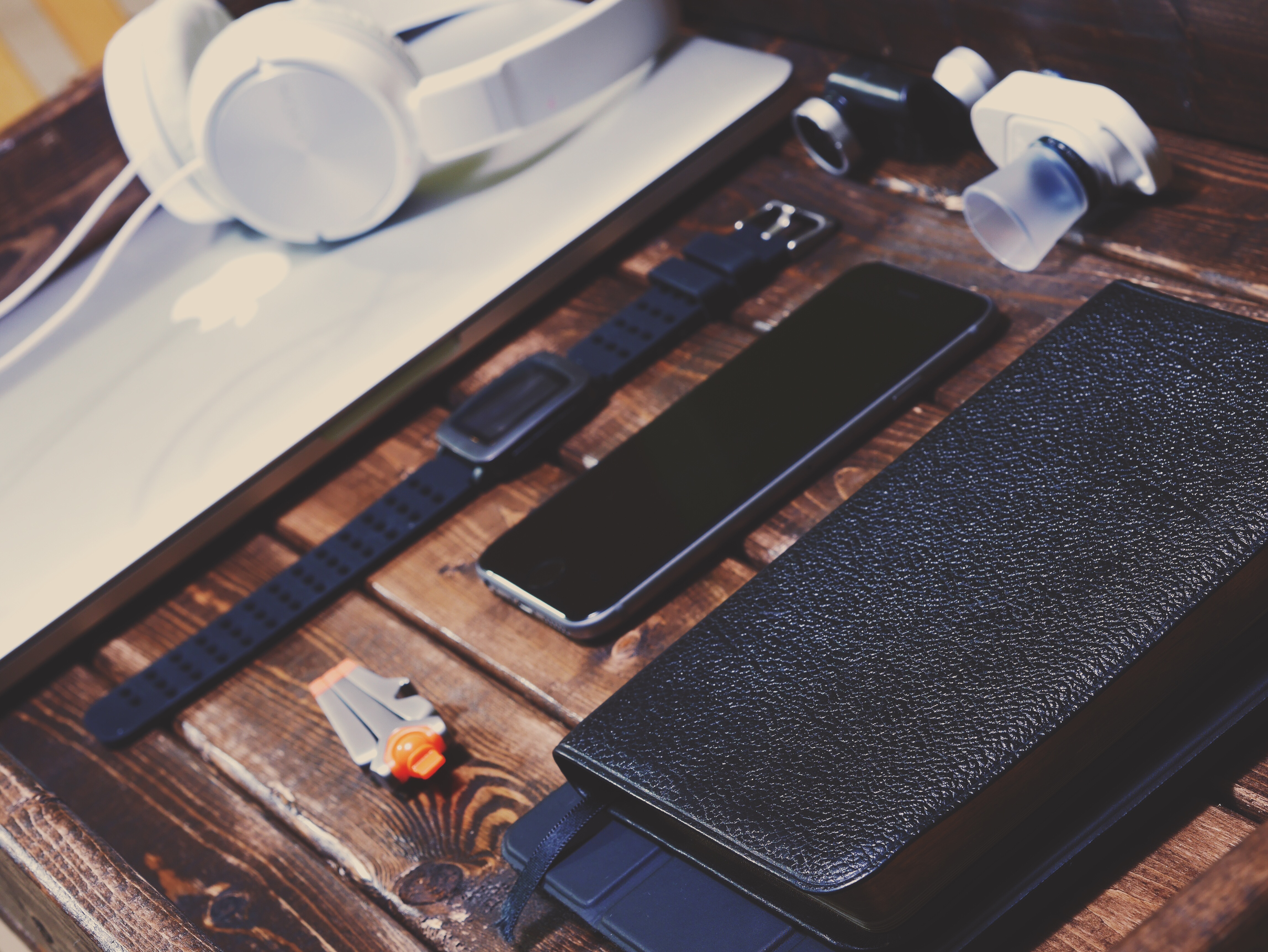 Apple MacBook with headphones, watch, and phone HD Wallpaper