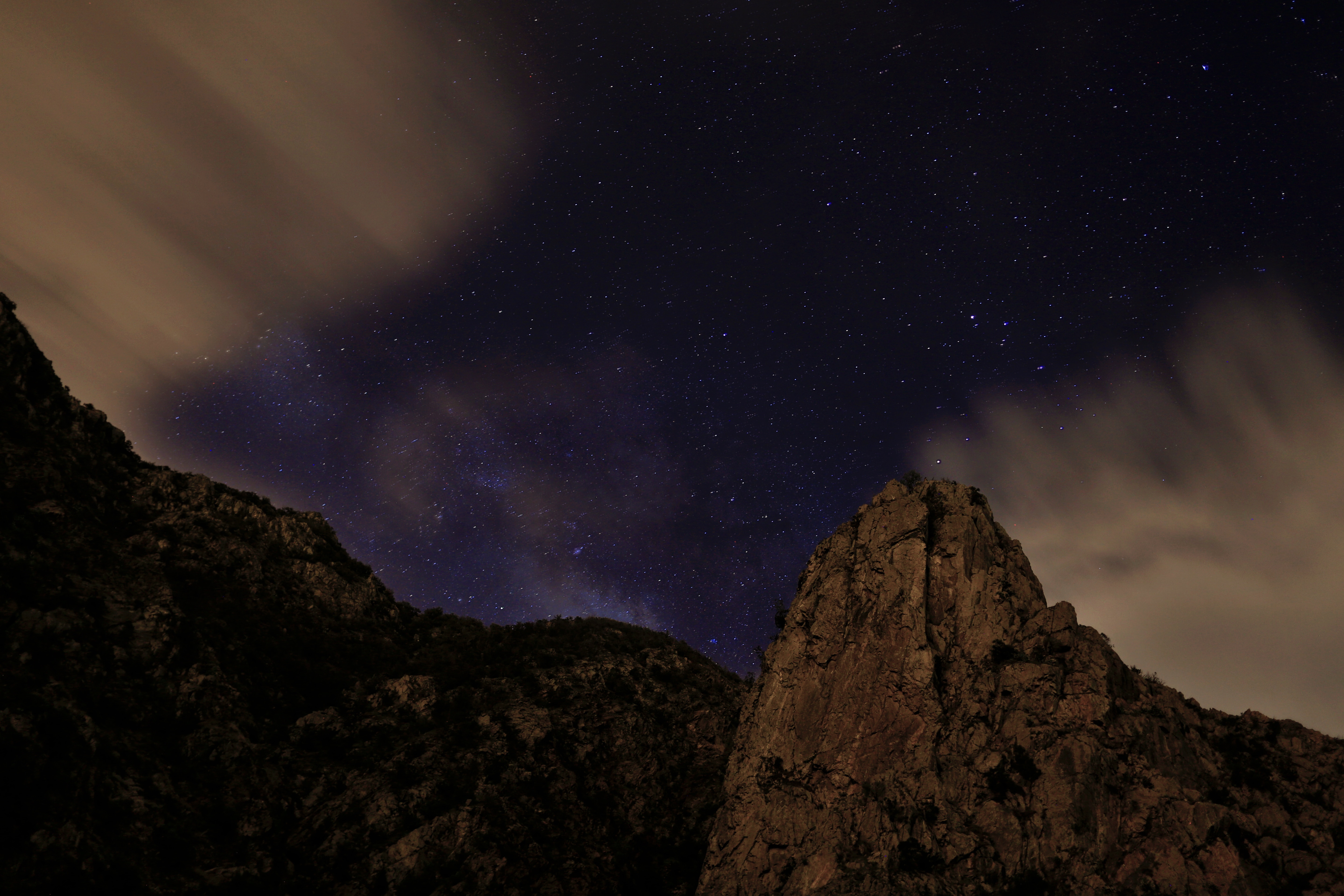 Night sky over rocky mountains with clouds HD Wallpaper