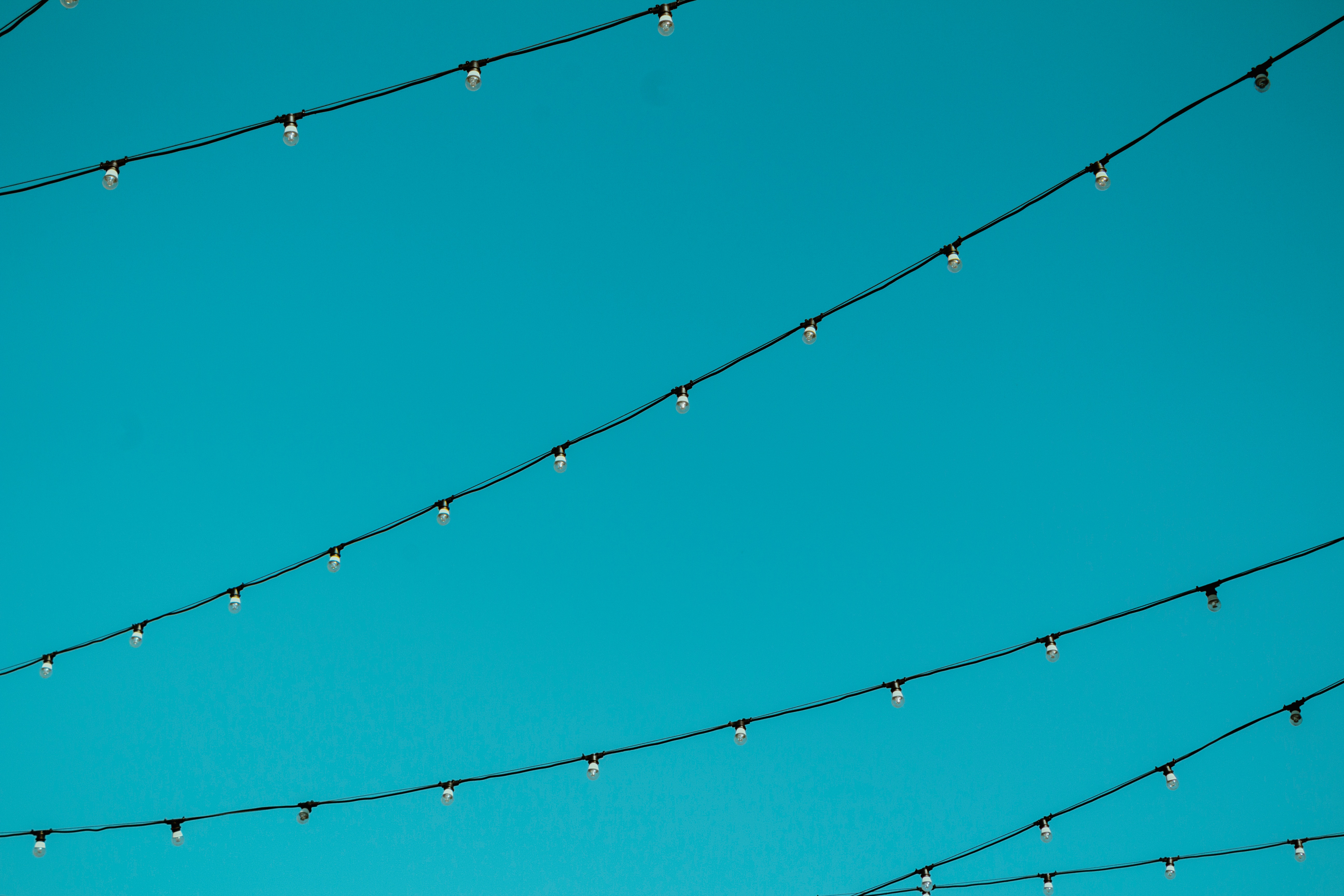 String lights against a bright blue sky HD Wallpaper