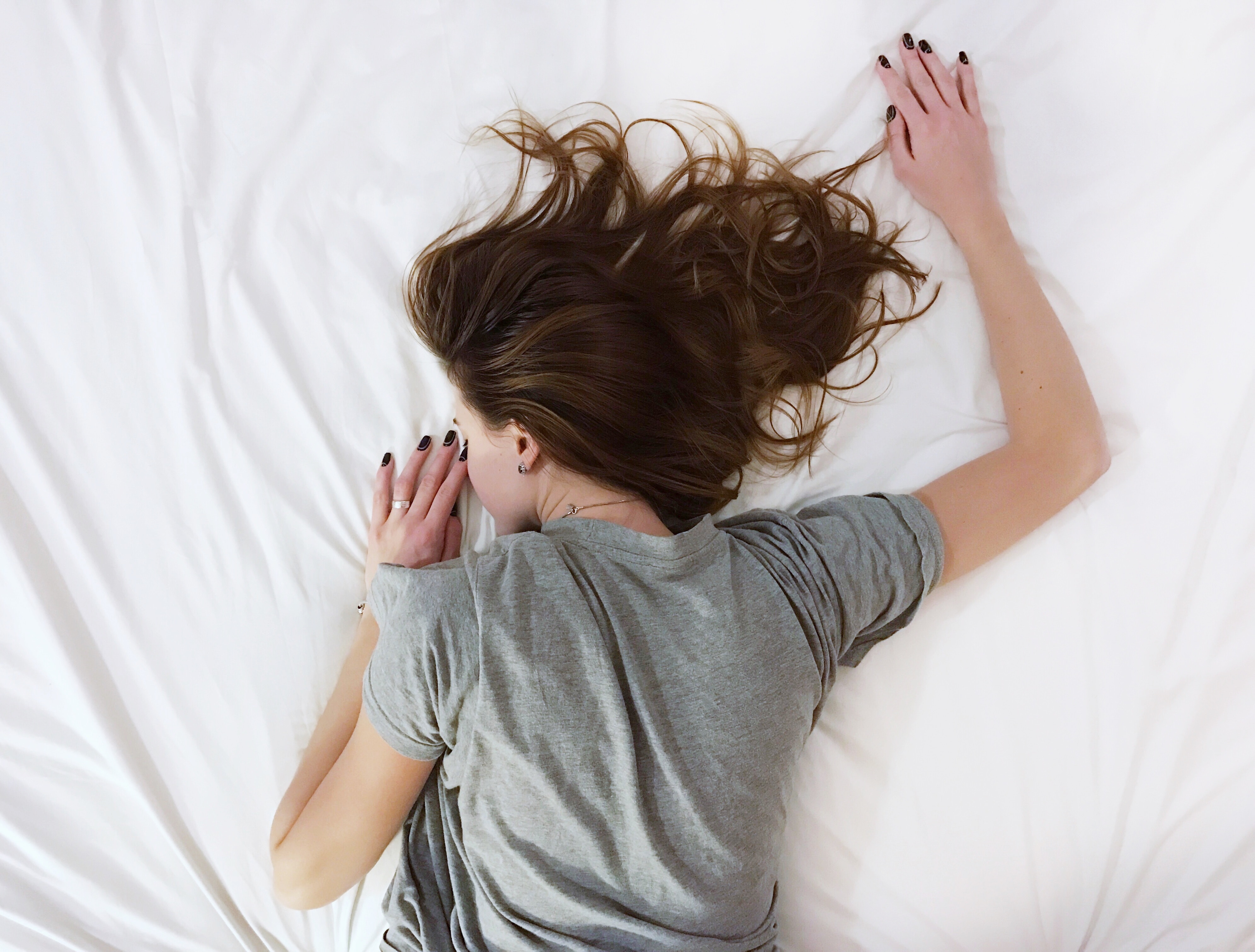 Woman sleeping on a white bed HD Wallpaper