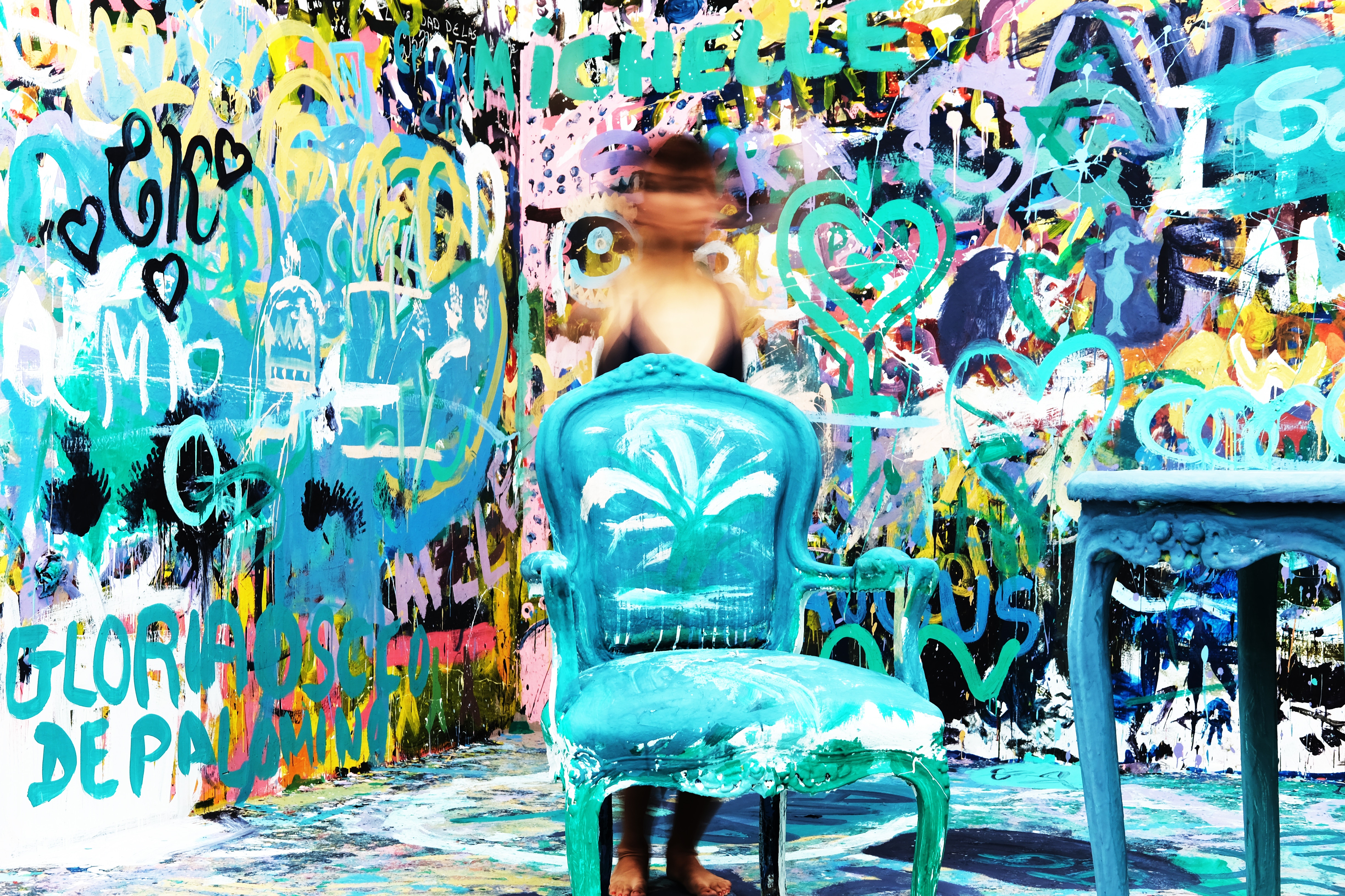 Person in front of graffiti art with blue chair HD Wallpaper