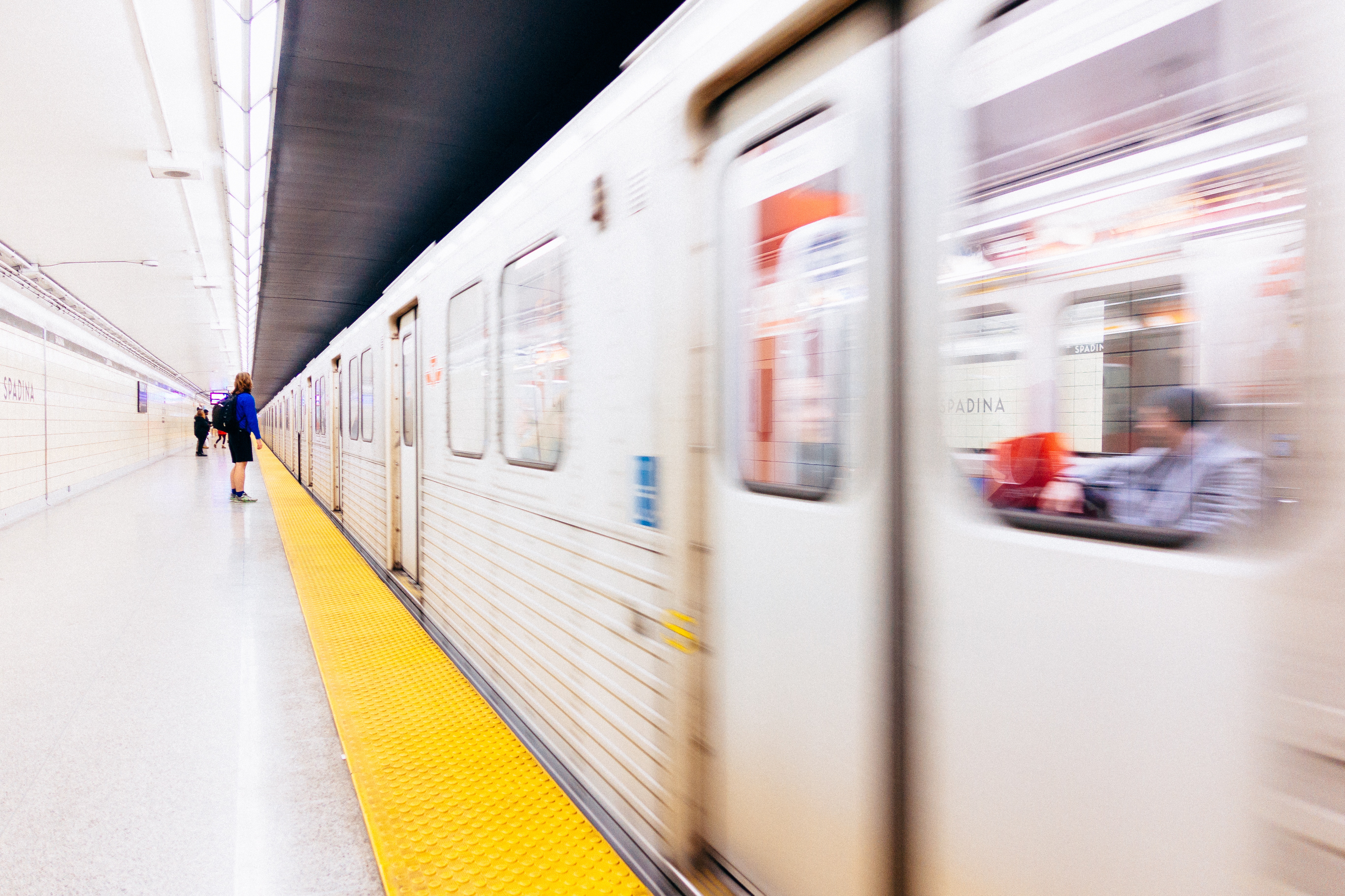 Spadina subway train in motion with passengers HD Wallpaper
