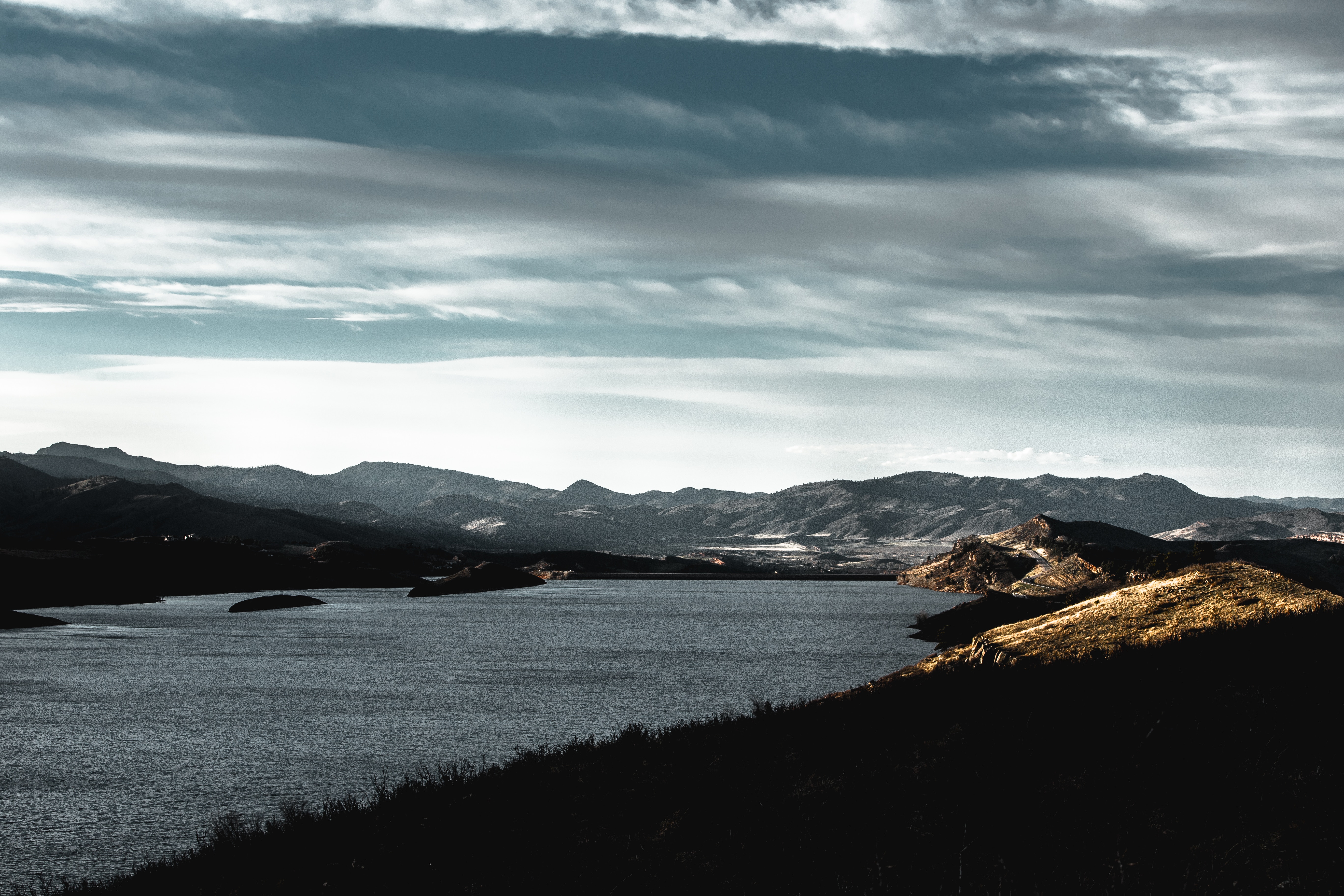 Lake and mountains under a cloudy sky HD Wallpaper