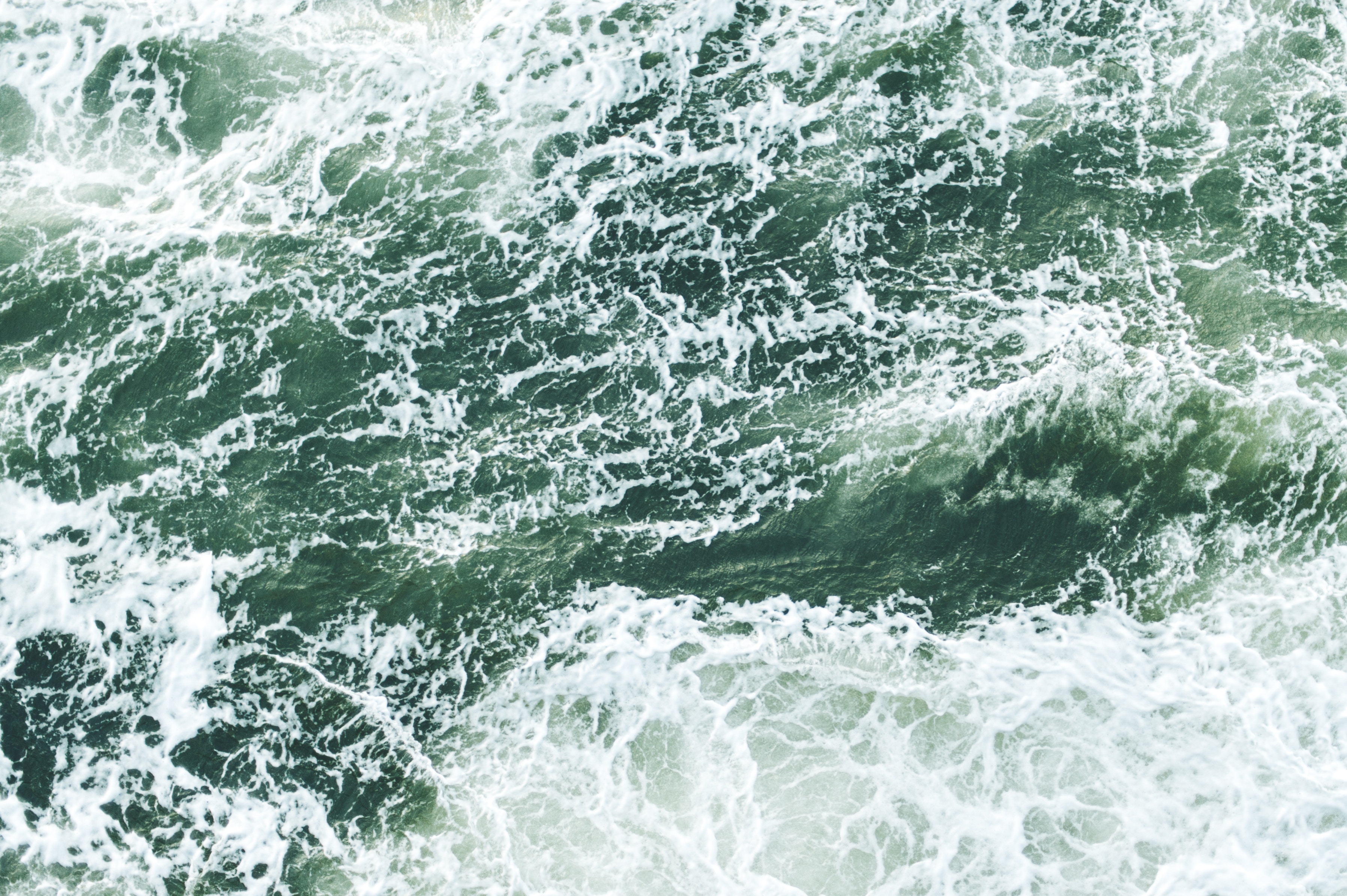 Turbulent green ocean waves with white foam HD Wallpaper