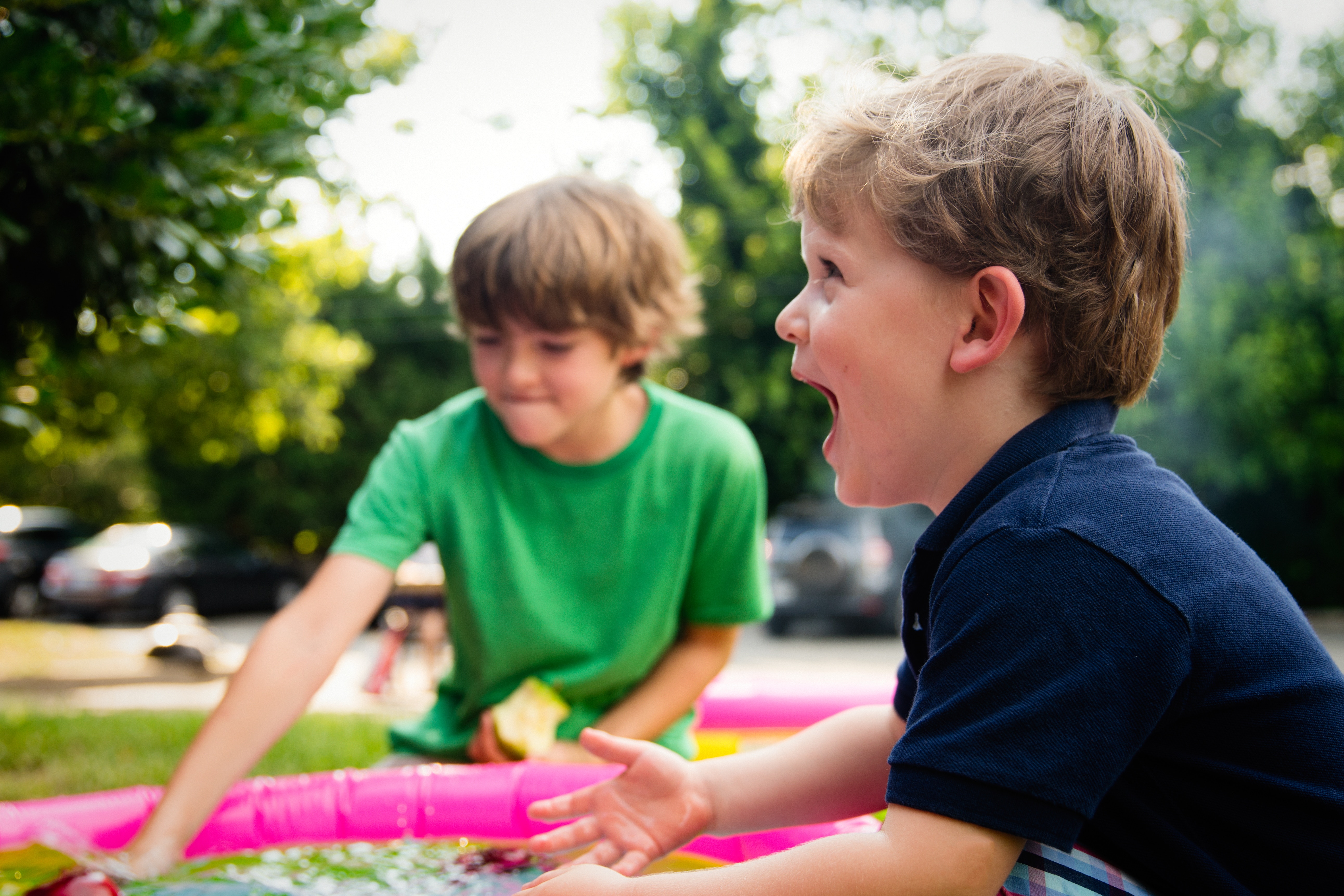 Two boys playing in a kiddie pool HD Wallpaper