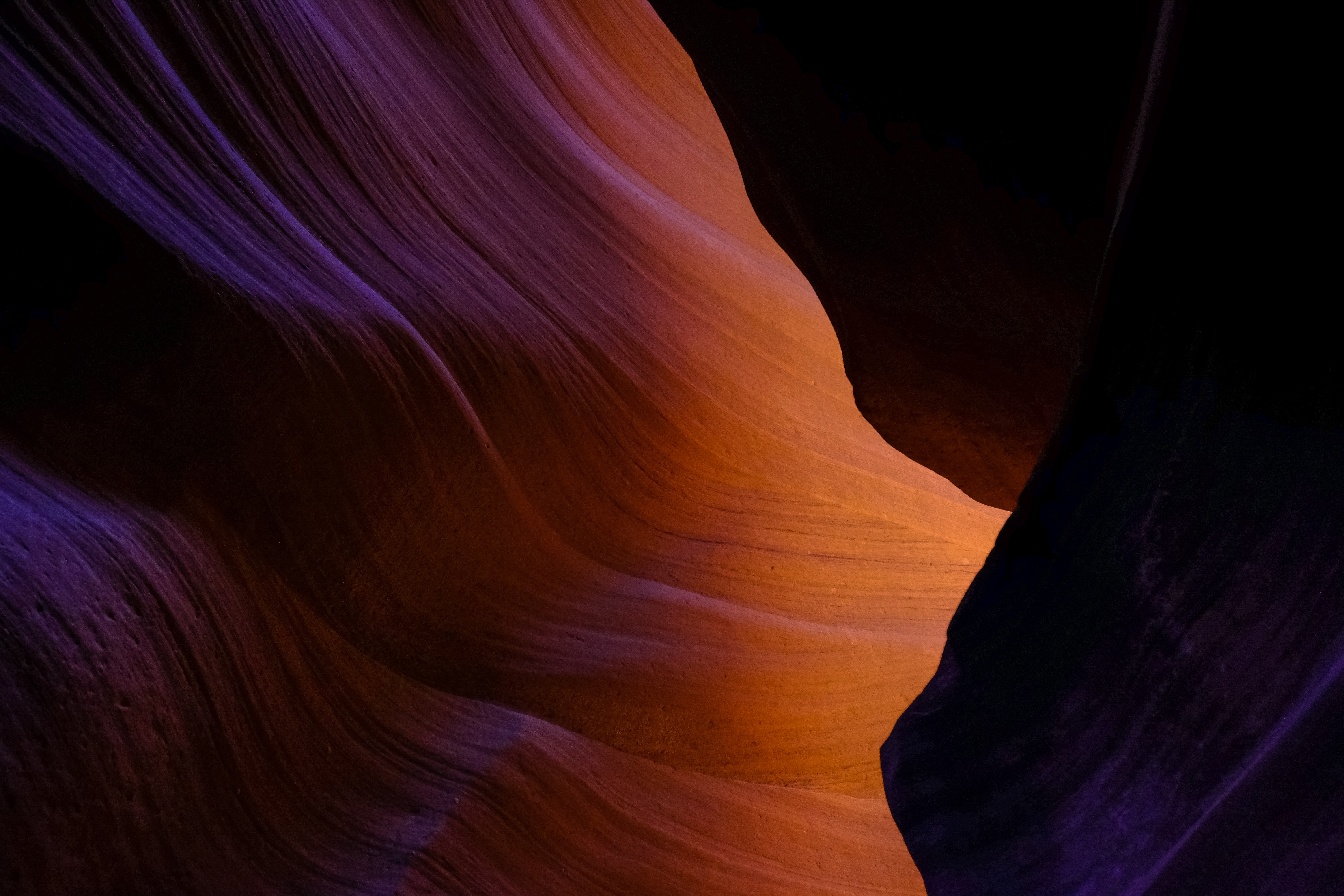 Abstract rock formation with purple and orange light HD Wallpaper