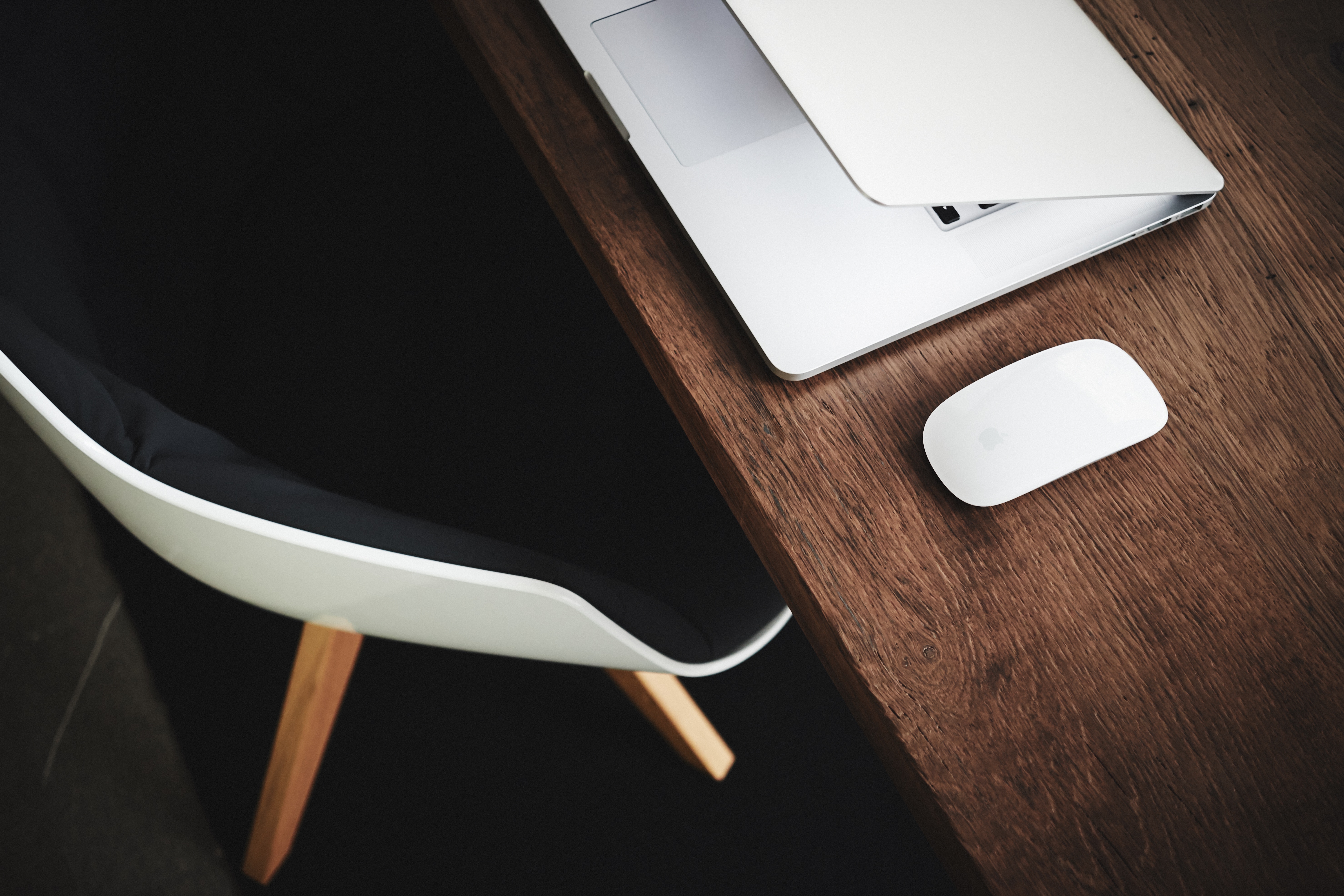 Apple MacBook and Magic Mouse on a wooden desk HD Wallpaper