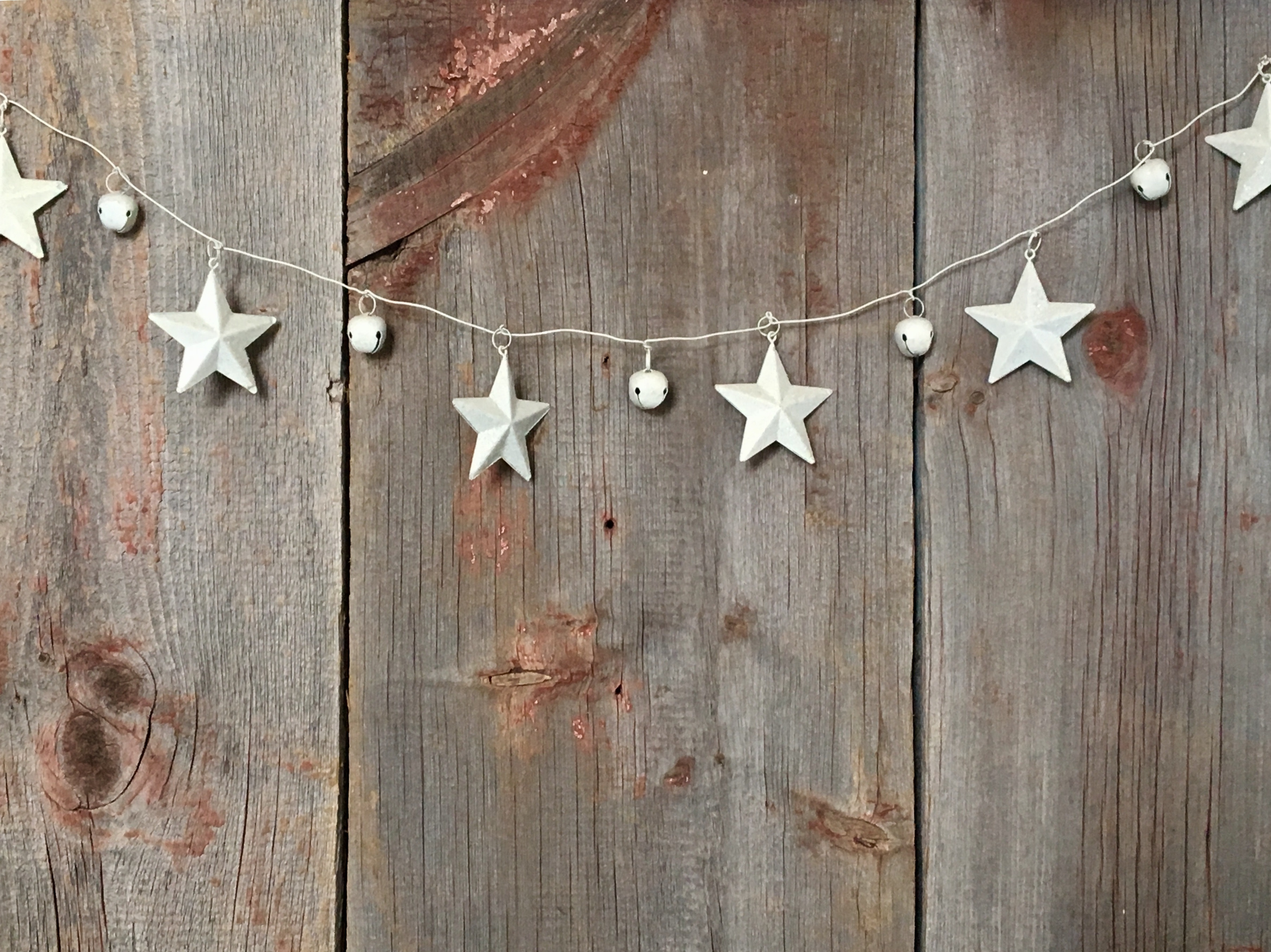 Rustic star and bell garland on wooden background HD Wallpaper