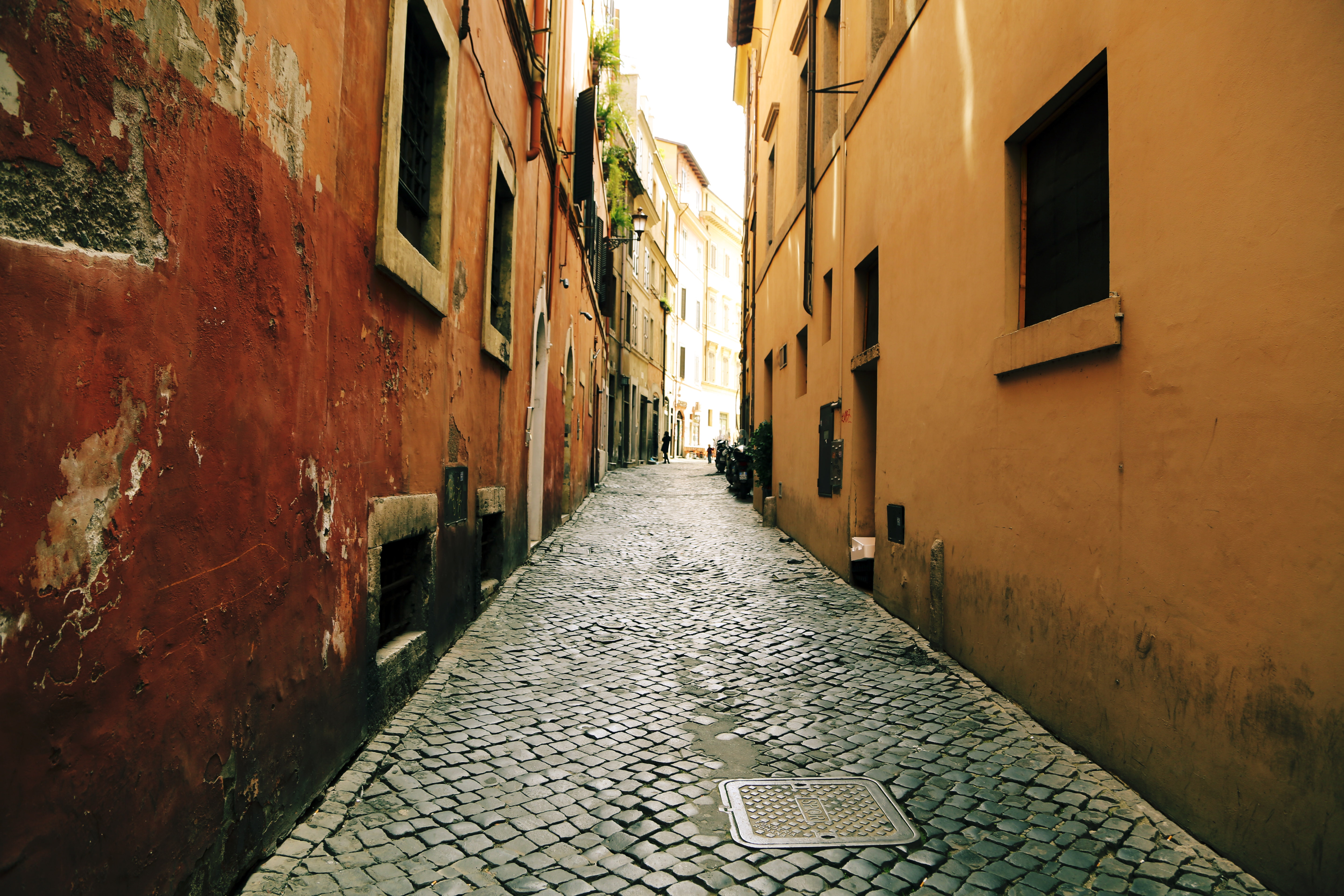 Cobblestone Alleyway with Old Buildings in a City HD Wallpaper