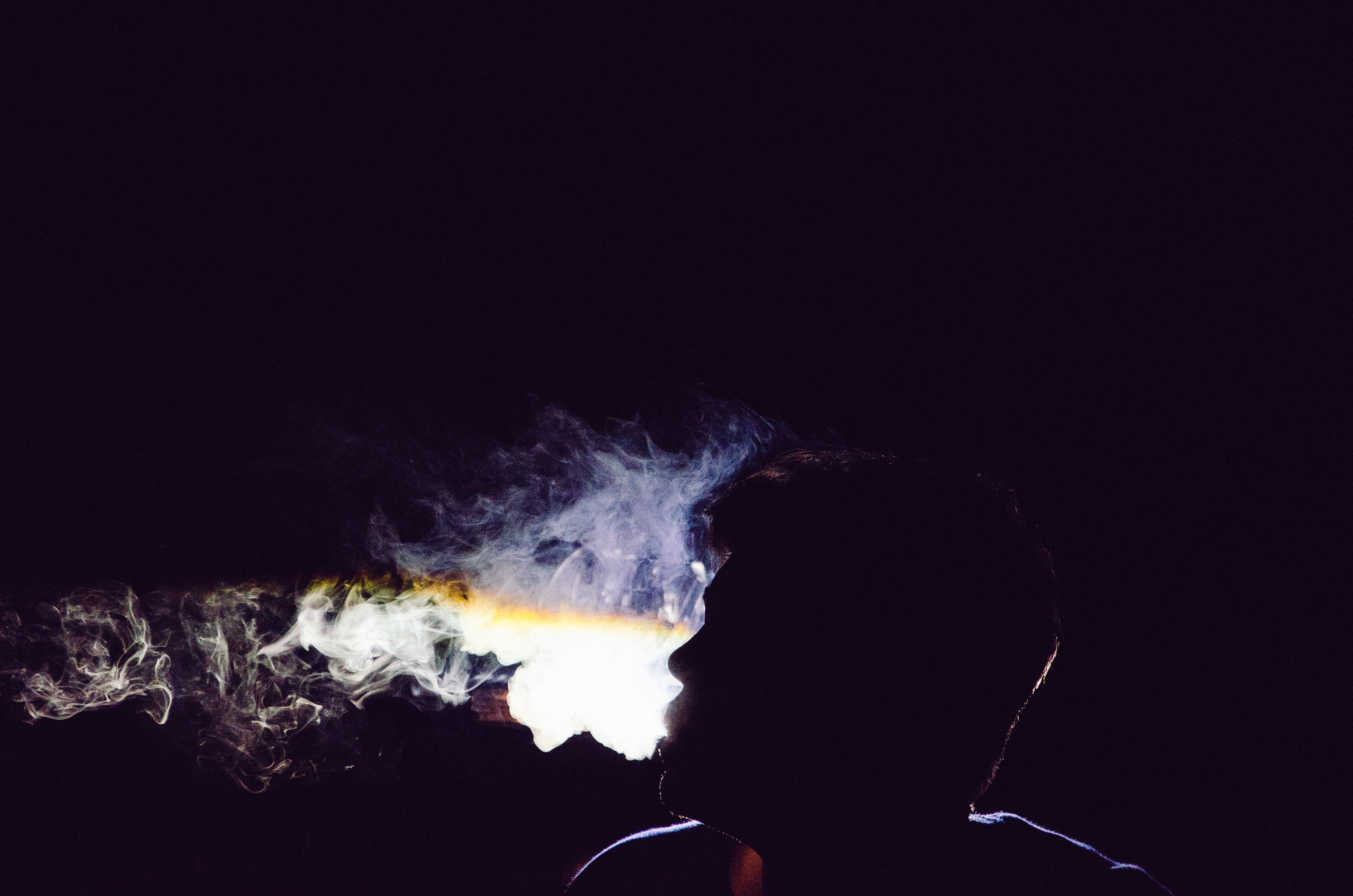 Silhouette of a man smoking in the dark HD Wallpaper
