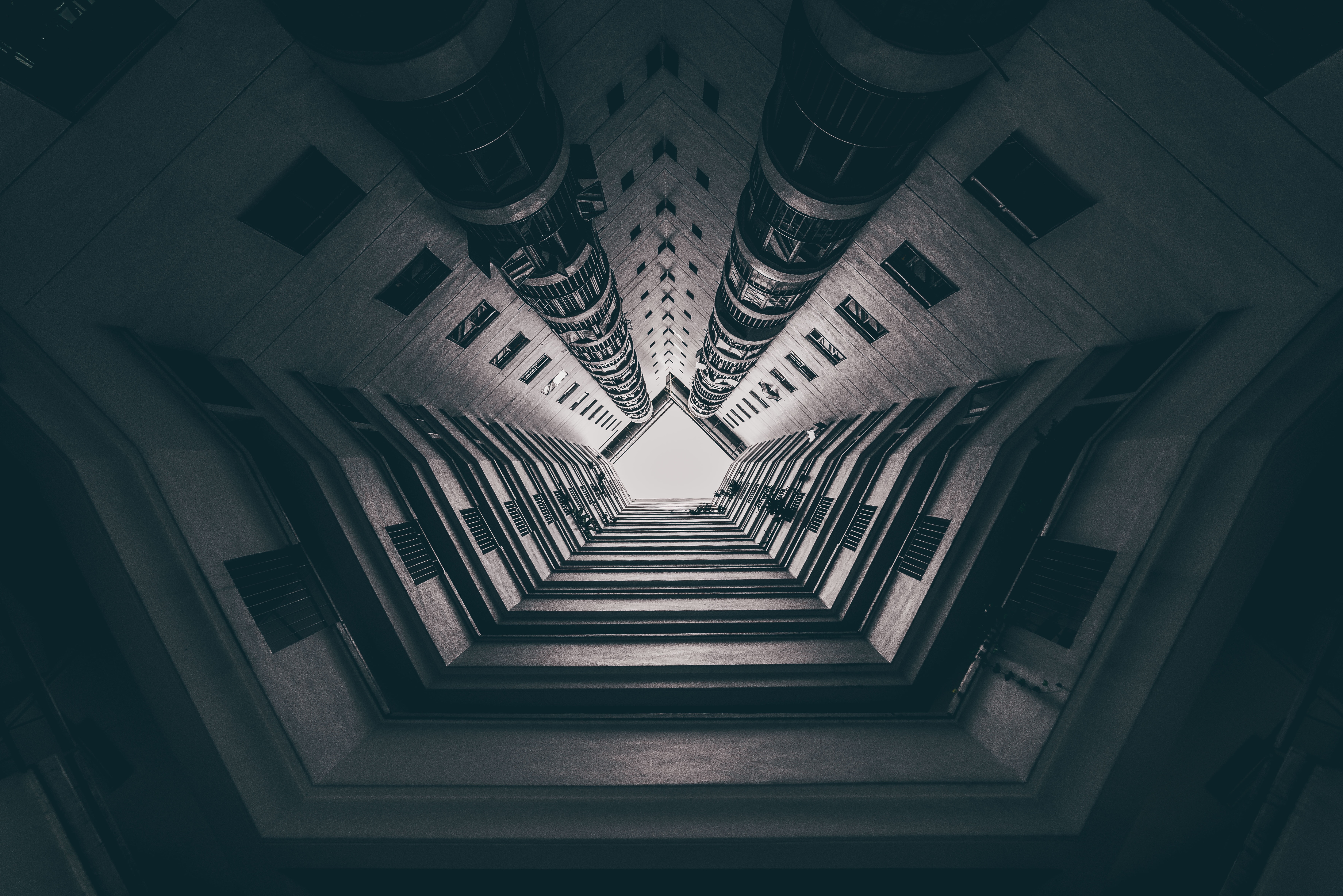 Looking up at a tall building courtyard in Singapore HD Wallpaper
