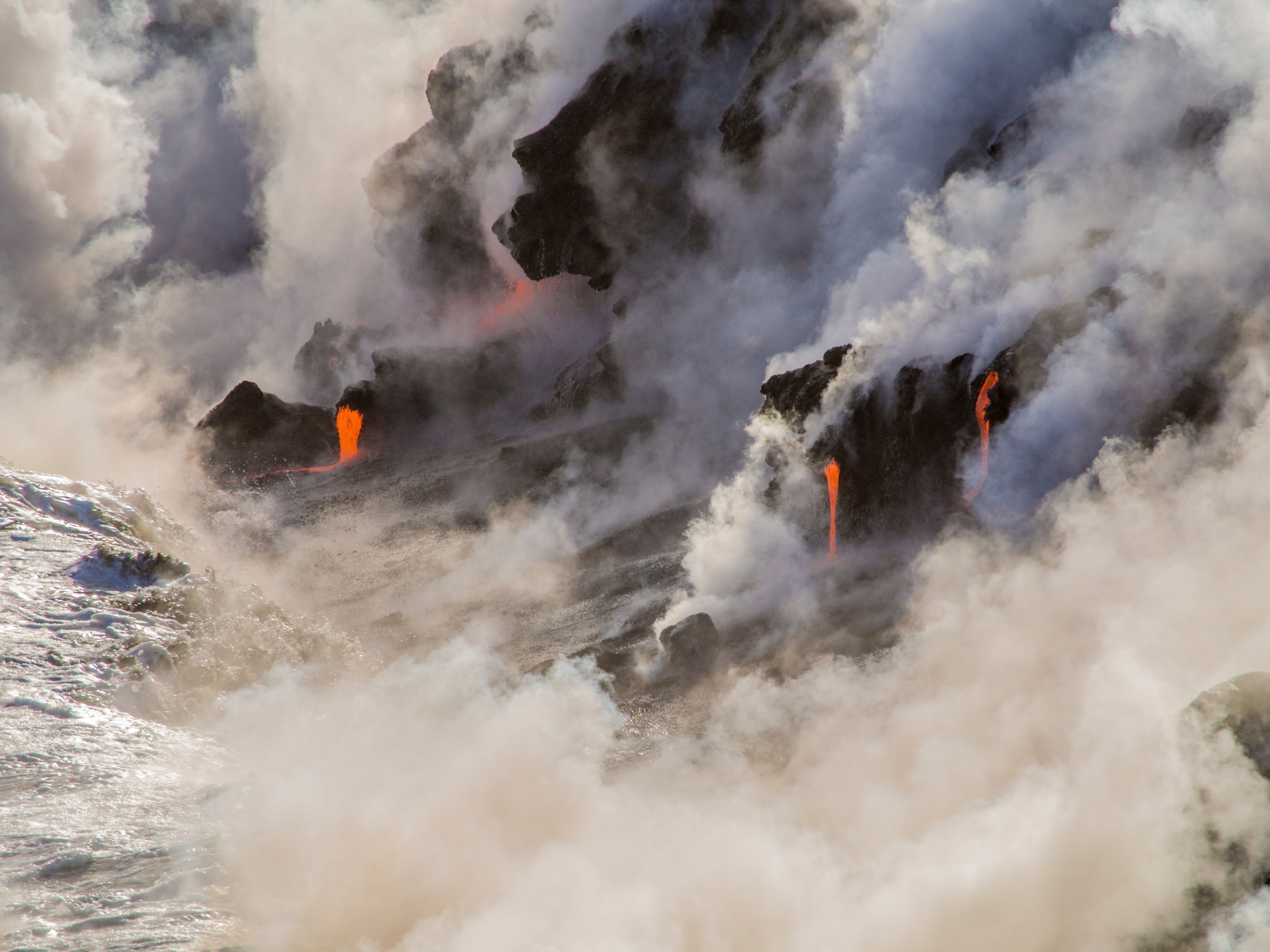 Lava flows into the ocean with steam and smoke HD Wallpaper