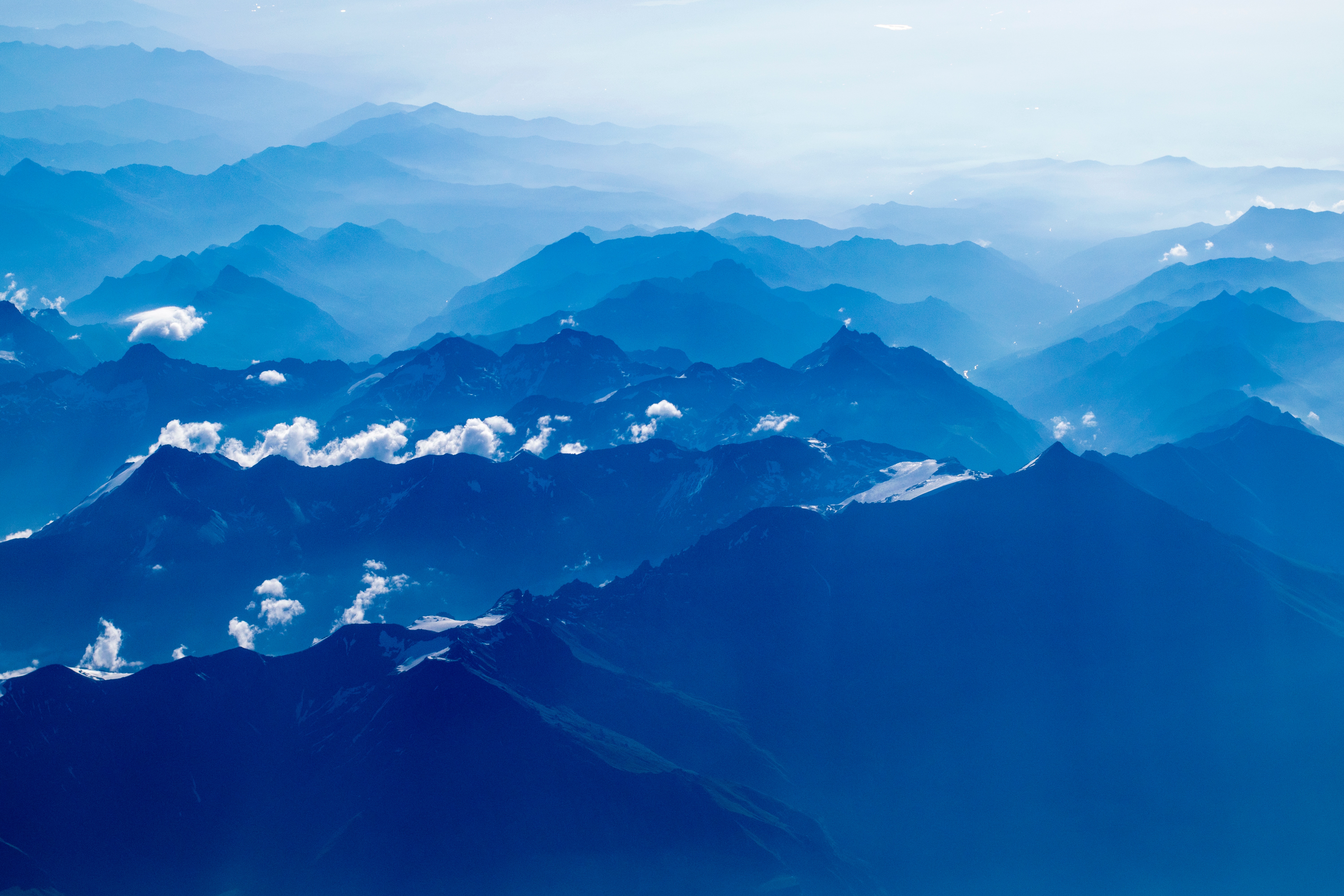 Aerial view of blue mountain ranges with clouds HD Wallpaper
