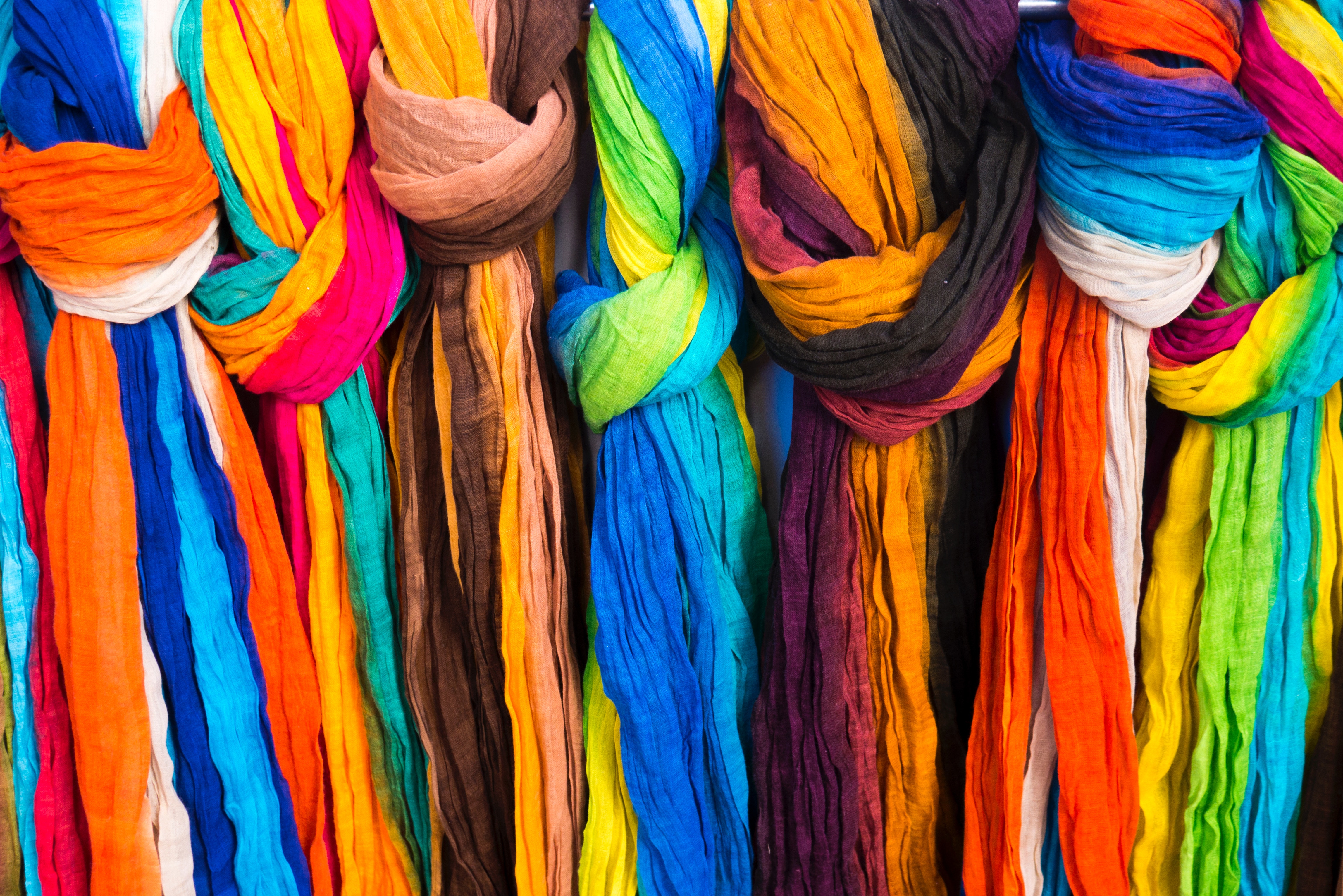 Colorful scarves hanging in a market HD Wallpaper