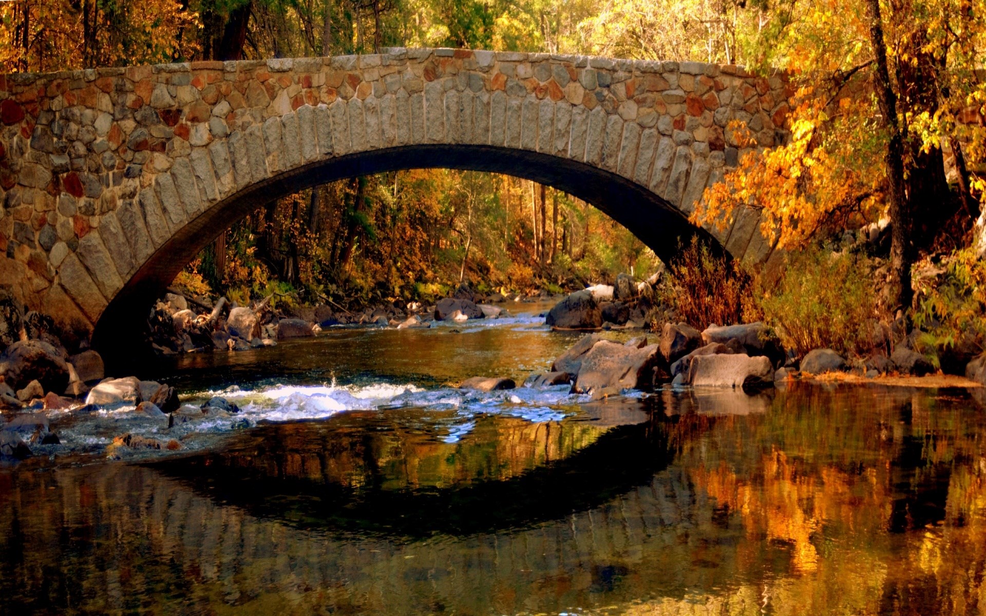 Stone bridge over a river in autumn HD Wallpaper