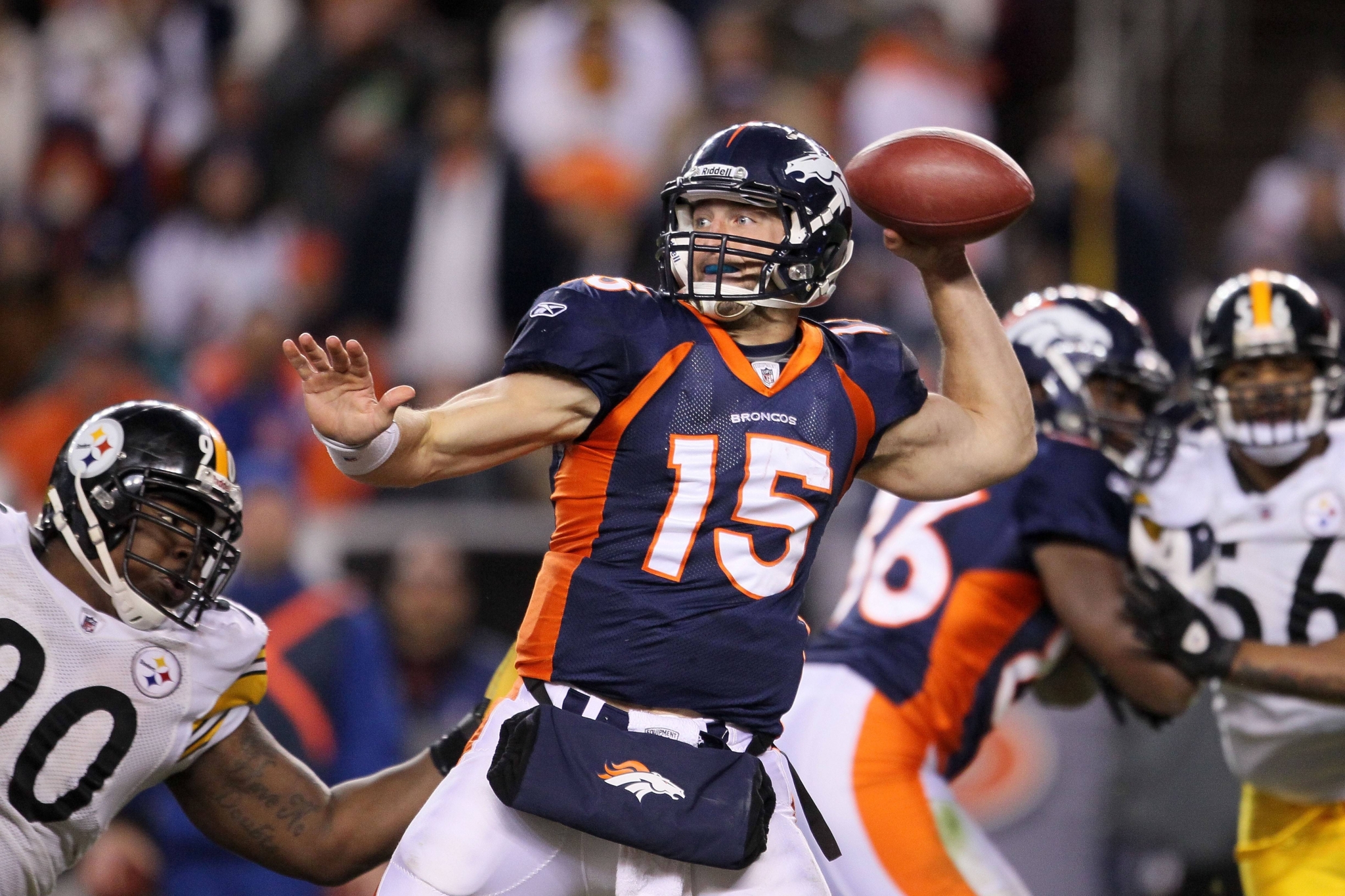 Tim Tebow throwing a football during an NFL game HD Wallpaper