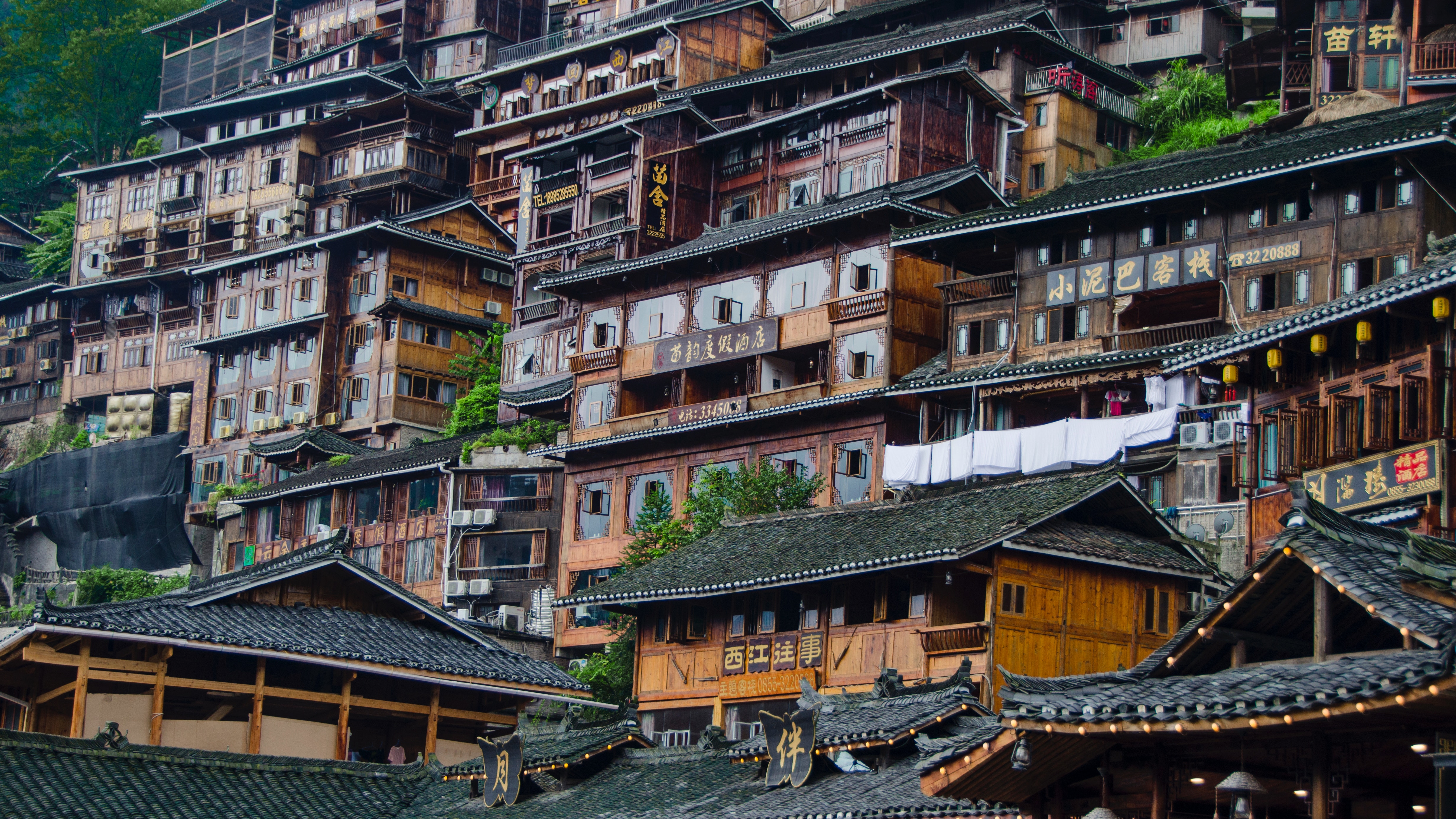 Traditional wooden buildings on a hillside HD Wallpaper