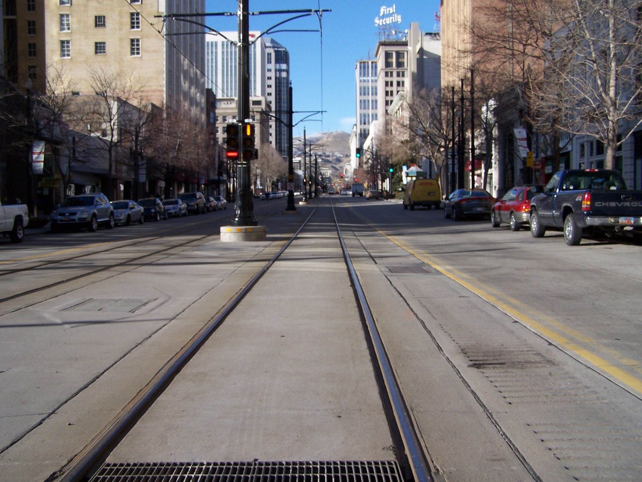City street with tram tracks and buildings HD Wallpaper