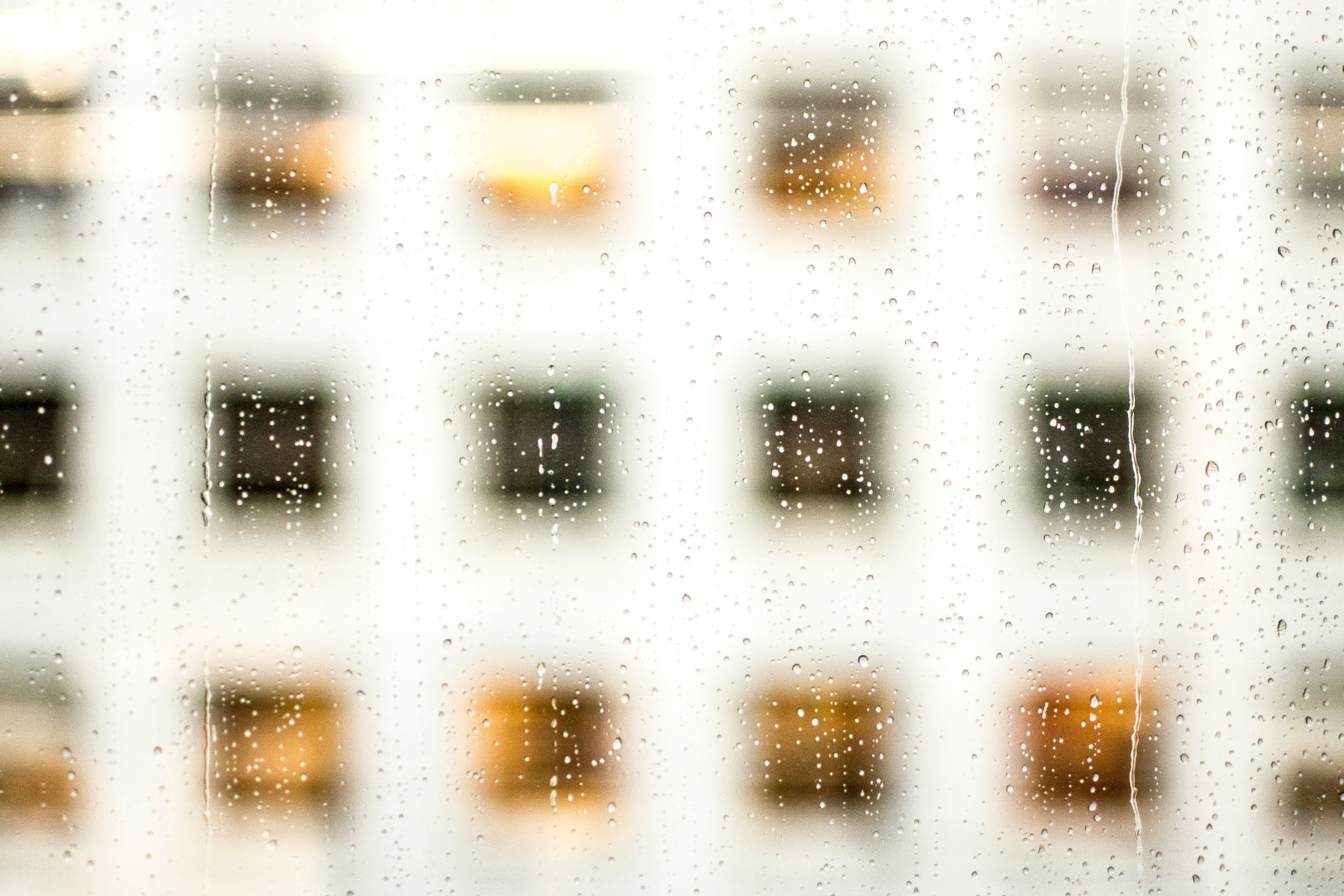 Rainy window with blurred building windows HD Wallpaper