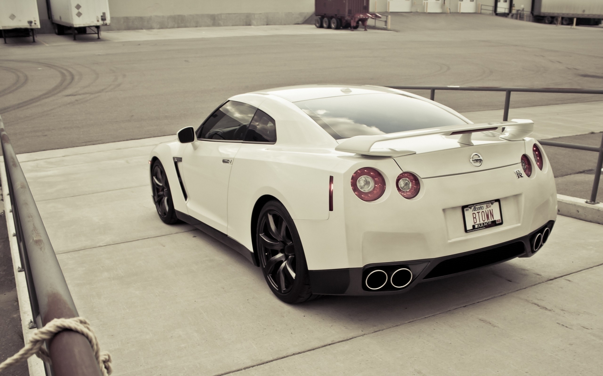 White Nissan GT-R parked outdoors HD Wallpaper
