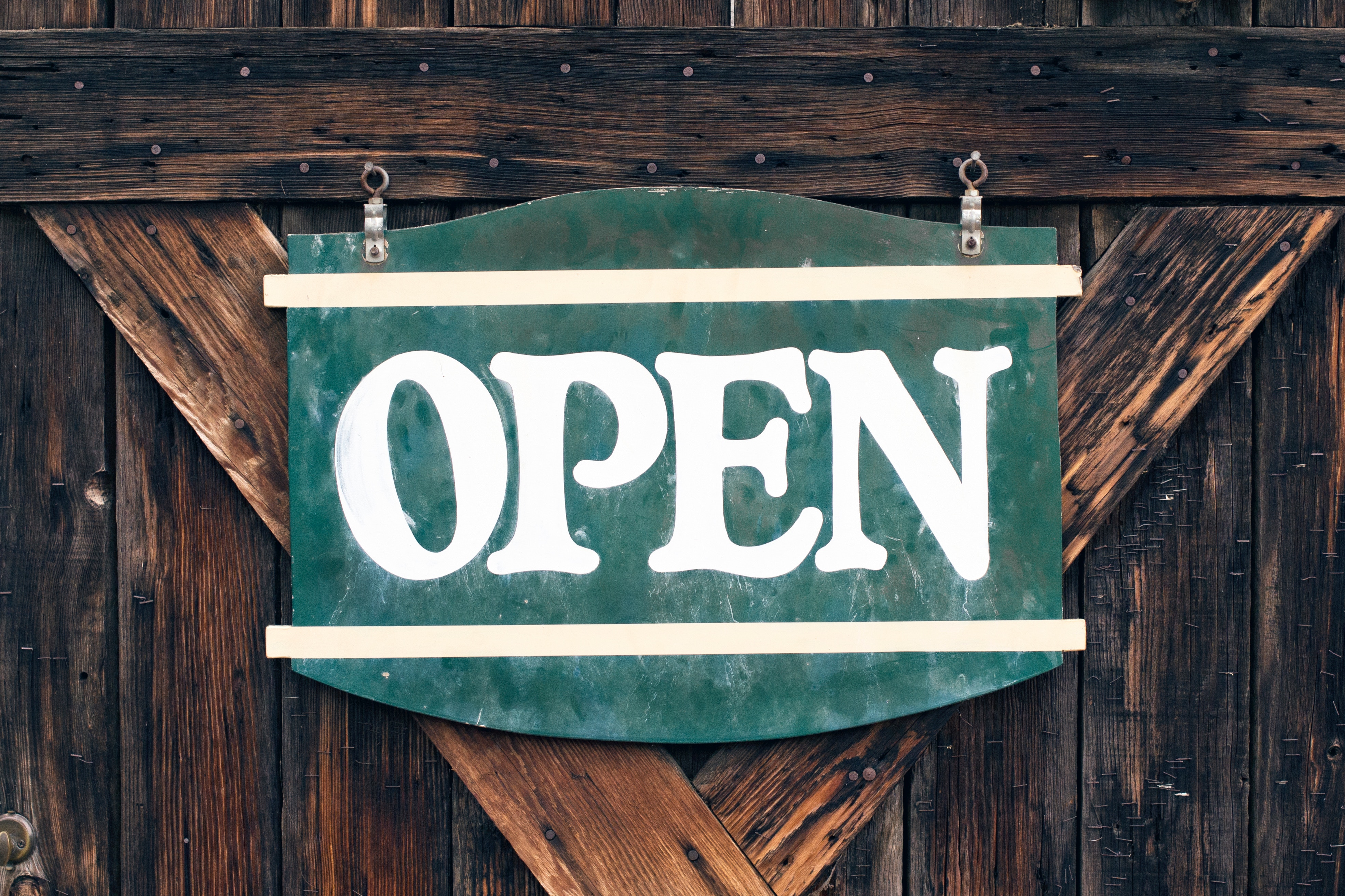 Rustic green "OPEN" sign on a wooden door HD Wallpaper
